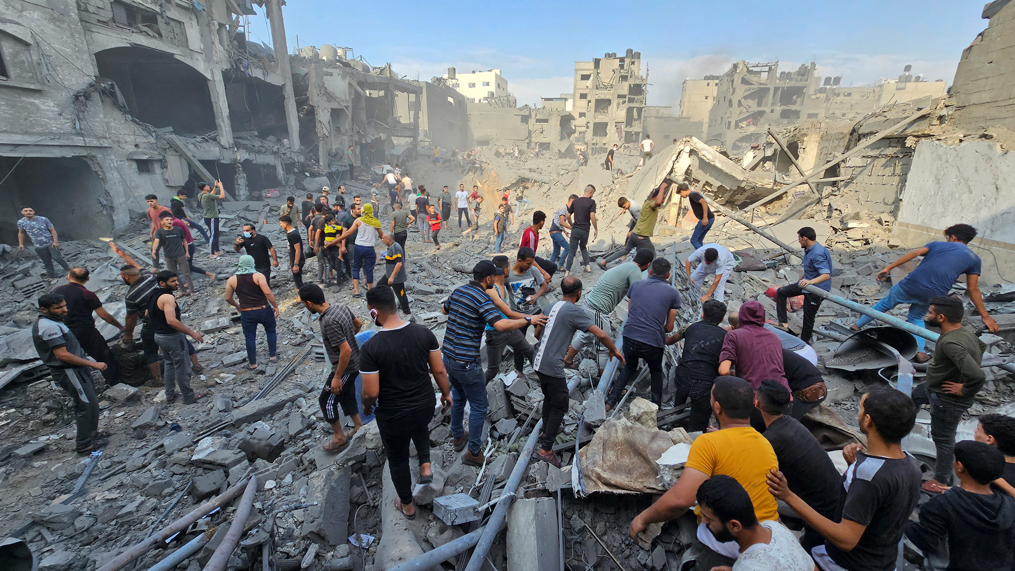 Palestinians search for casualties at the site of Israeli strikes on houses in Jabalya refugee camp in northern Gaza, on October 31.