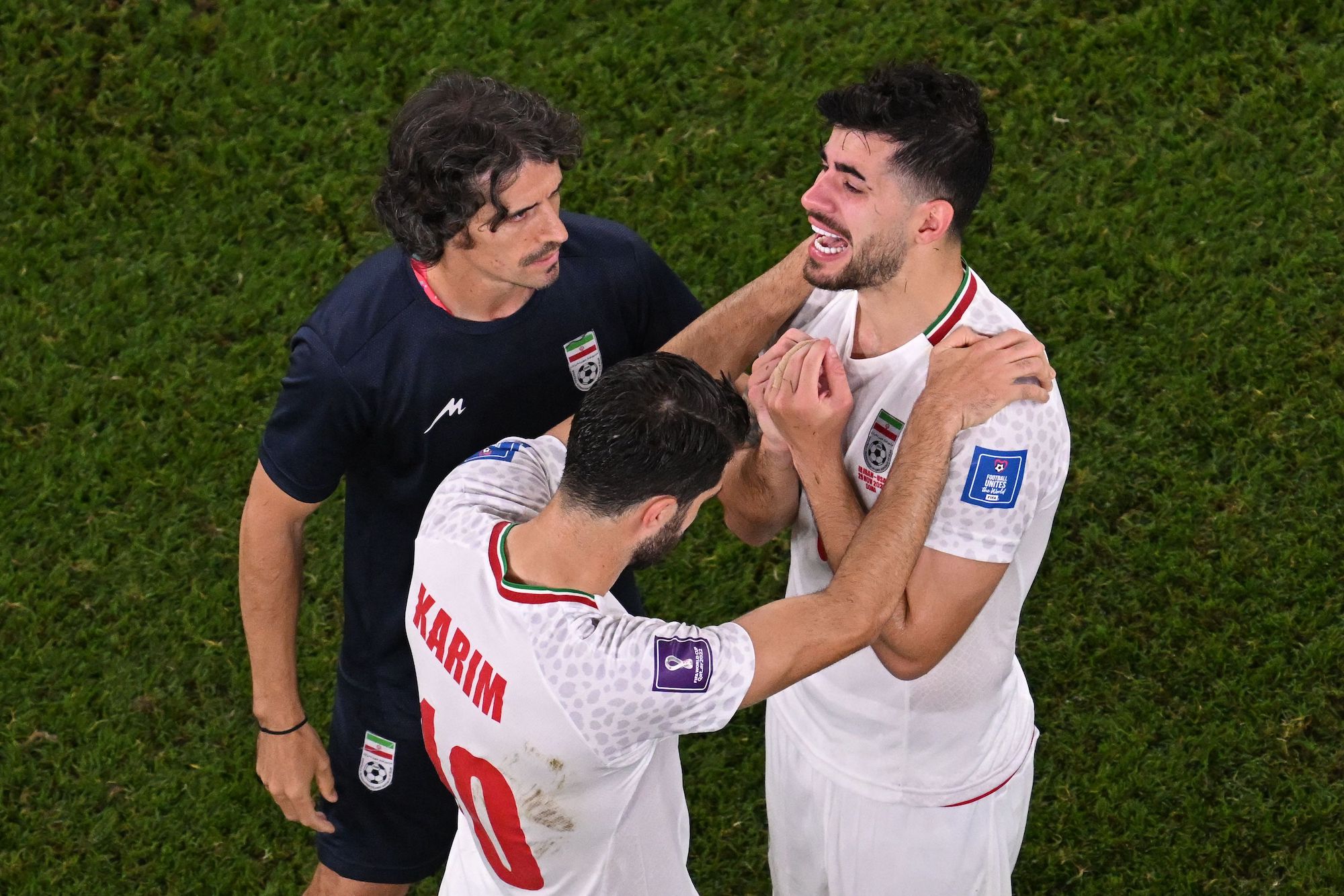 Iranian forward Karim Ansarifard and midfielder Saeid Ezatolahi cry after a loss against USA at Al-Thumama Stadium on Tuesday.