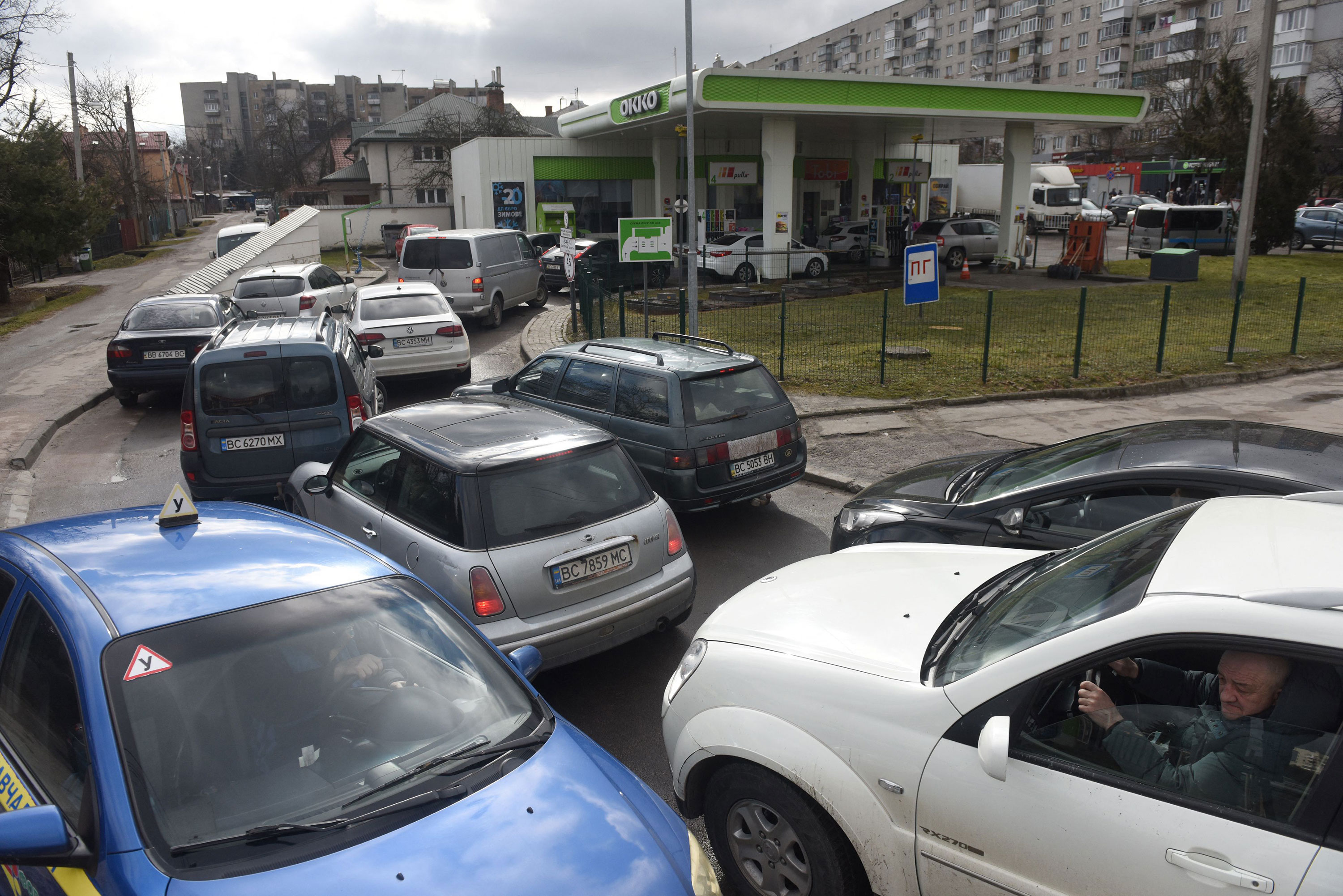 People wait in line at a gas station in Lviv, Ukraine, on February 24.
