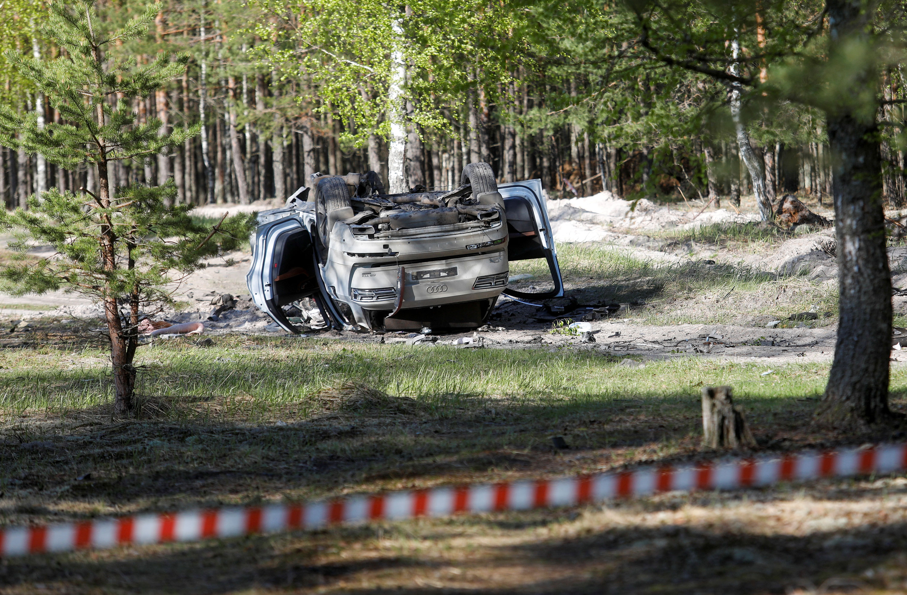 A damaged white Audi Q7 car is overturned after Russian military blogger Zakhar Prilepin was allegedly wounded in a bomb attack in Nizhny Novgorod, Russia, on May 6.