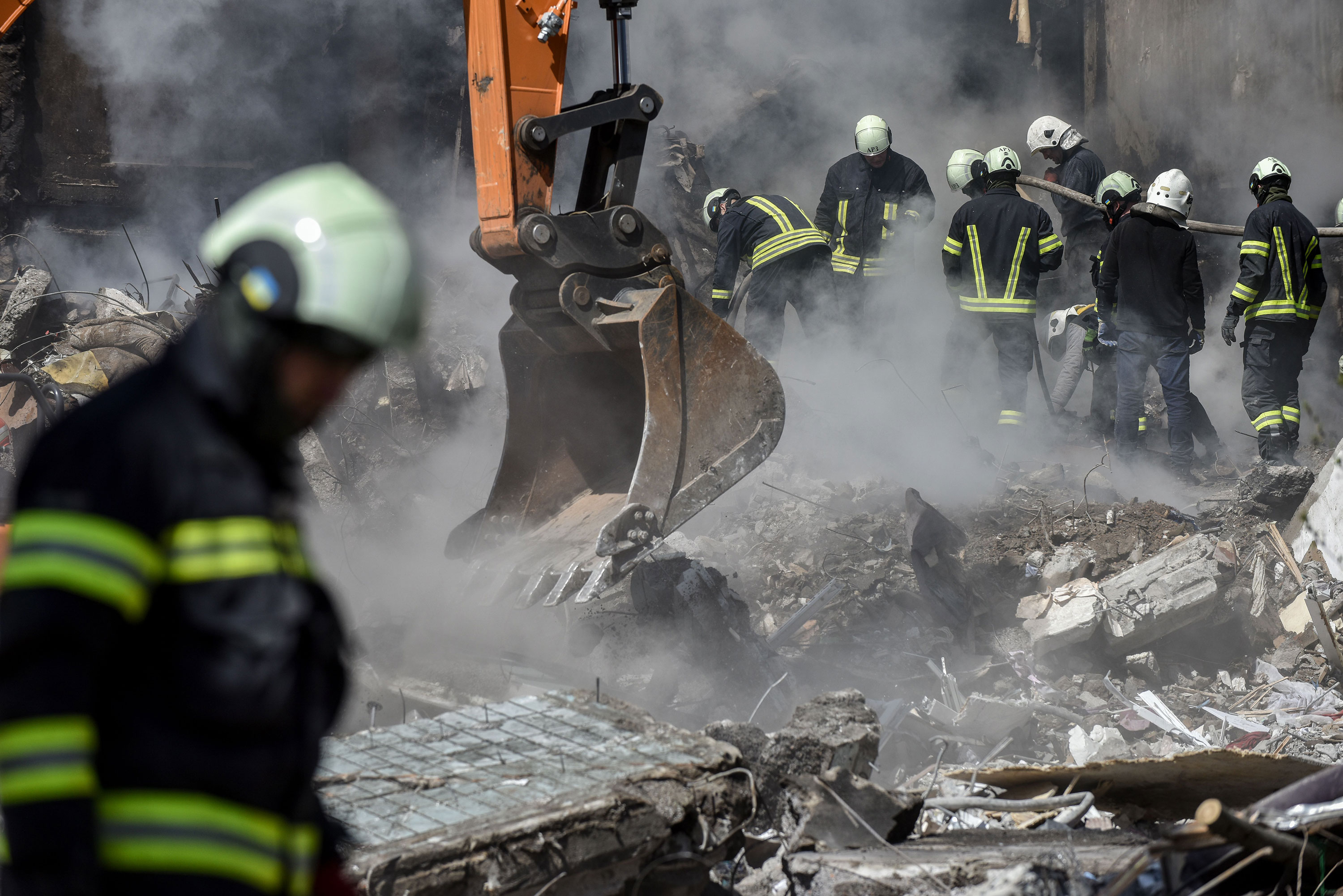 Rescuers work at the site of a damaged residential building in Uman, Ukraine, on Friday.