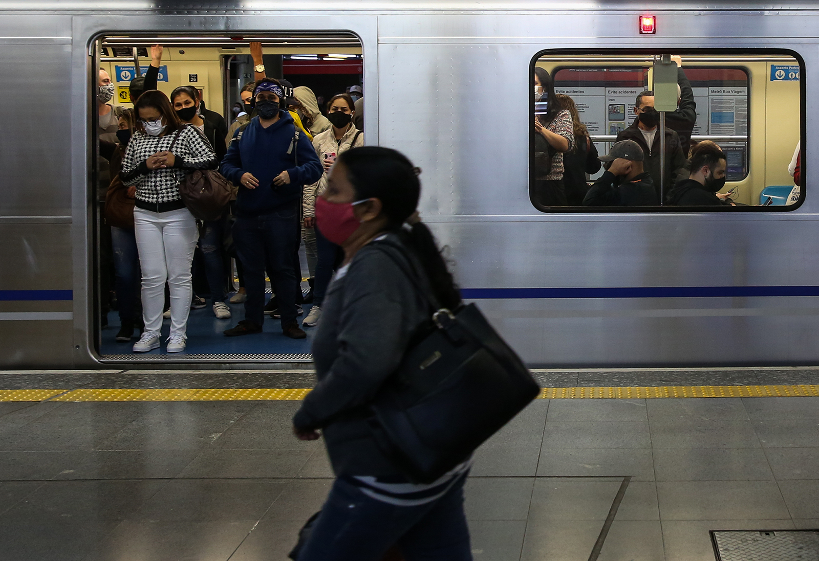 Passengers wearing face masks ride a subway car in downtown Sao Paulo on June 29, in Sao Paulo, Brazil. 