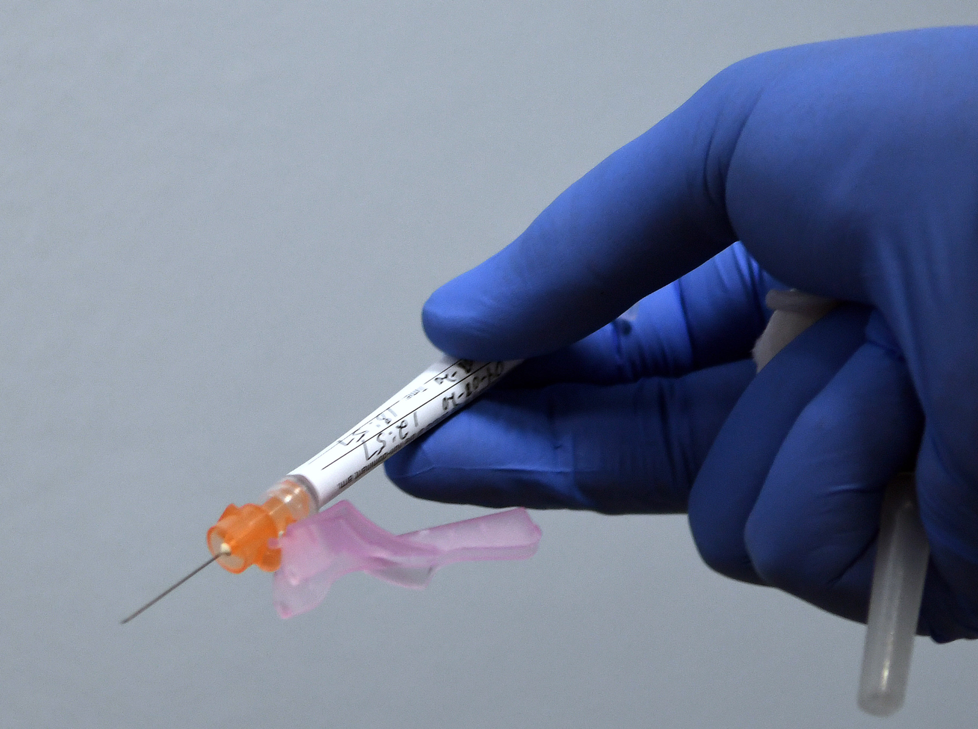 A syringe containing either the vaccine or a placebo is prepared for a participant in a Phase 3 COVID-19 vaccine clinical trial sponsored by Moderna at Accel Research Sites on August 4 in DeLand, Florida.