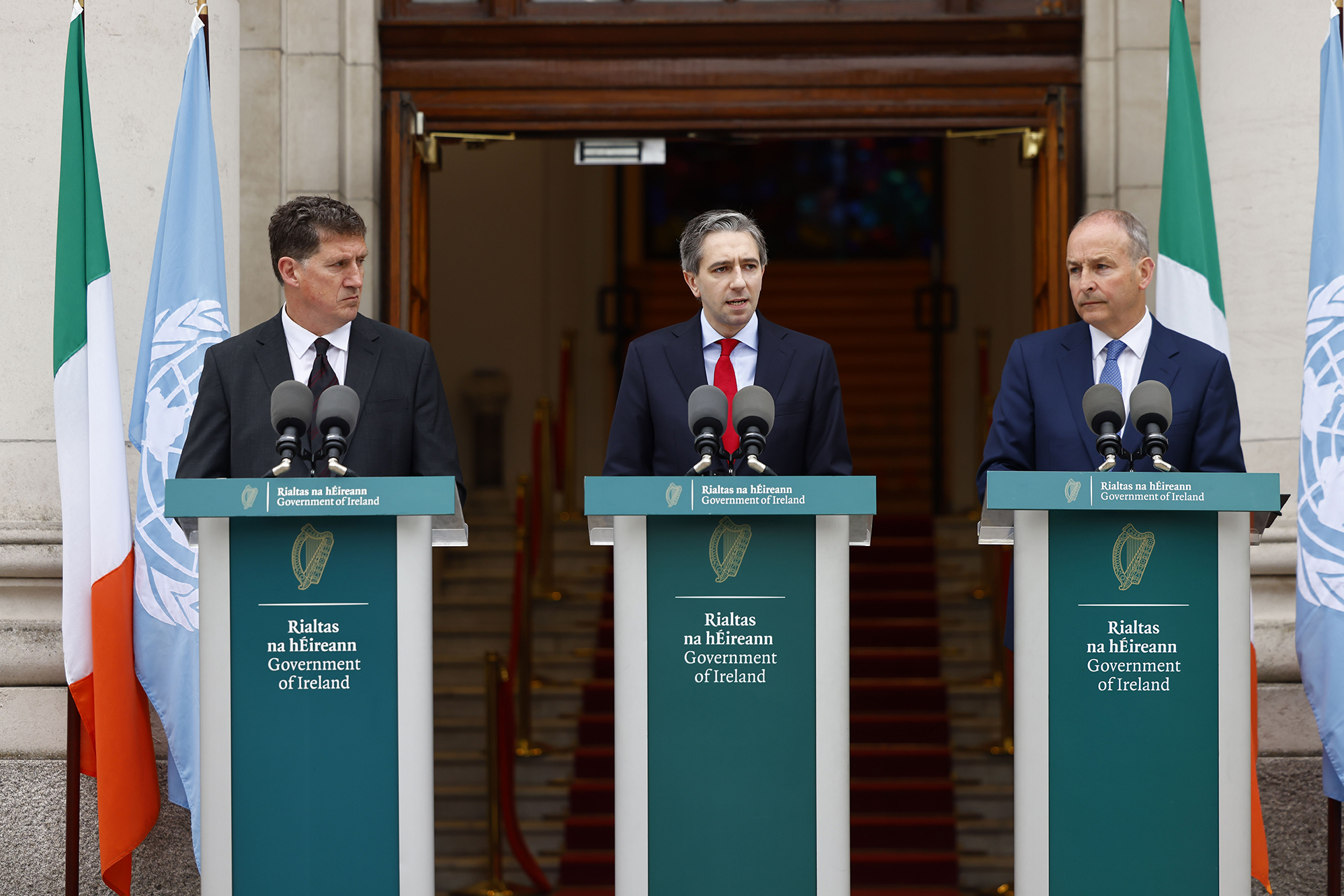 Irish Taoiseach Simon Harris, center, Foreign Minister Micheal Martin, right, and Environment Minister Eamon Ryan hold a press conference at the Government Buildings in Dublin, Ireland, on May 22.
