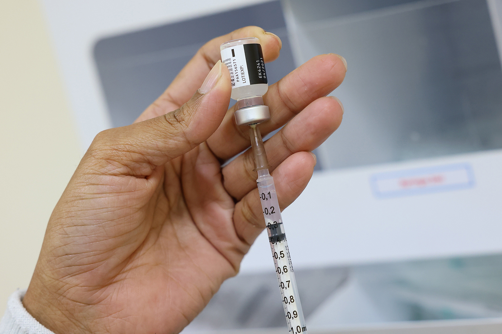 A nurse prepares a dose of the Pfizer-BioNTech vaccine at al-Barsha Health Center in Dubai on Christmas Eve
