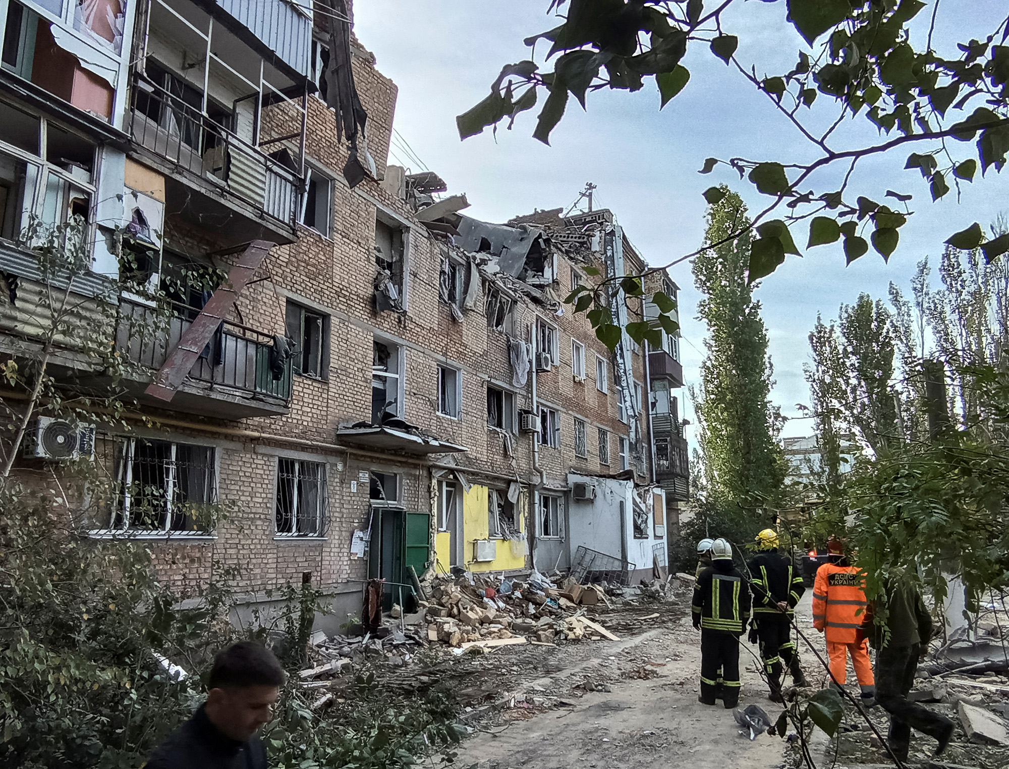 Rescuers work at the site of an apartment building damaged by a Russian military strike in Mykolaiv, on October 13.