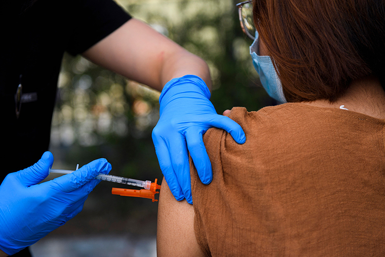 A 15-year-old receives a first dose of the Pfizer Covid-19 vaccine at a mobile vaccination clinic at the Weingart East Los Angeles YMCA on May 14, 2021 in Los Angeles, California. 