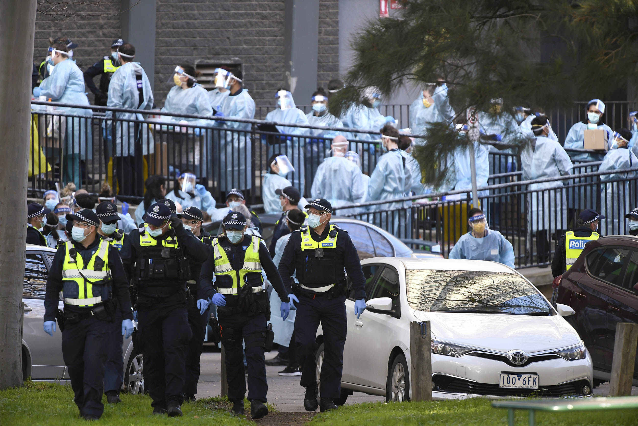 Police officers and health care workers outside a locked-down public housing tower in Melbourne, Australia, on July 8. 