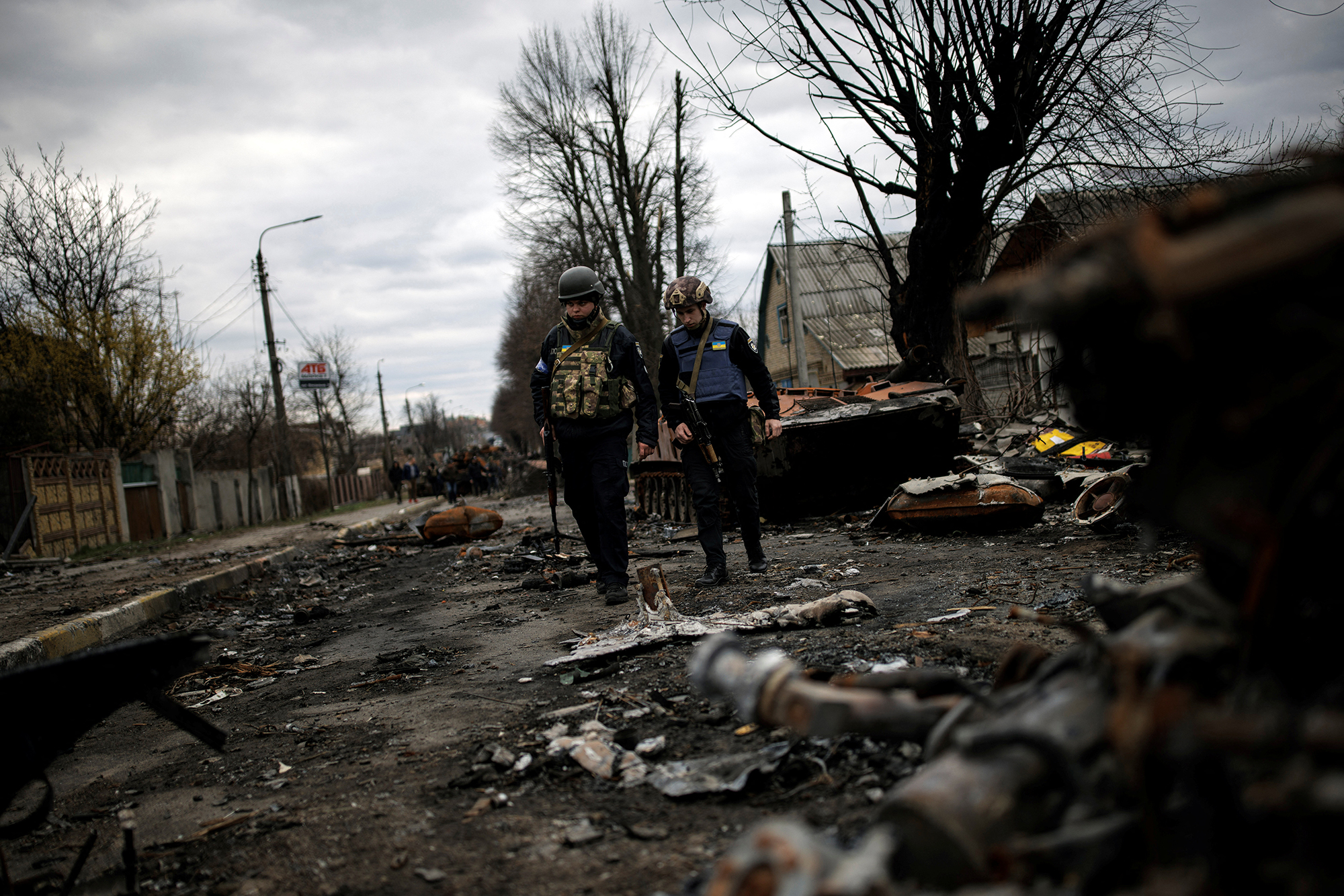 Volunteers of the Territorial Defence Forces walk next to destroyed Russian tanks and armoured vehicles in Bucha, Ukraine, on April 6.