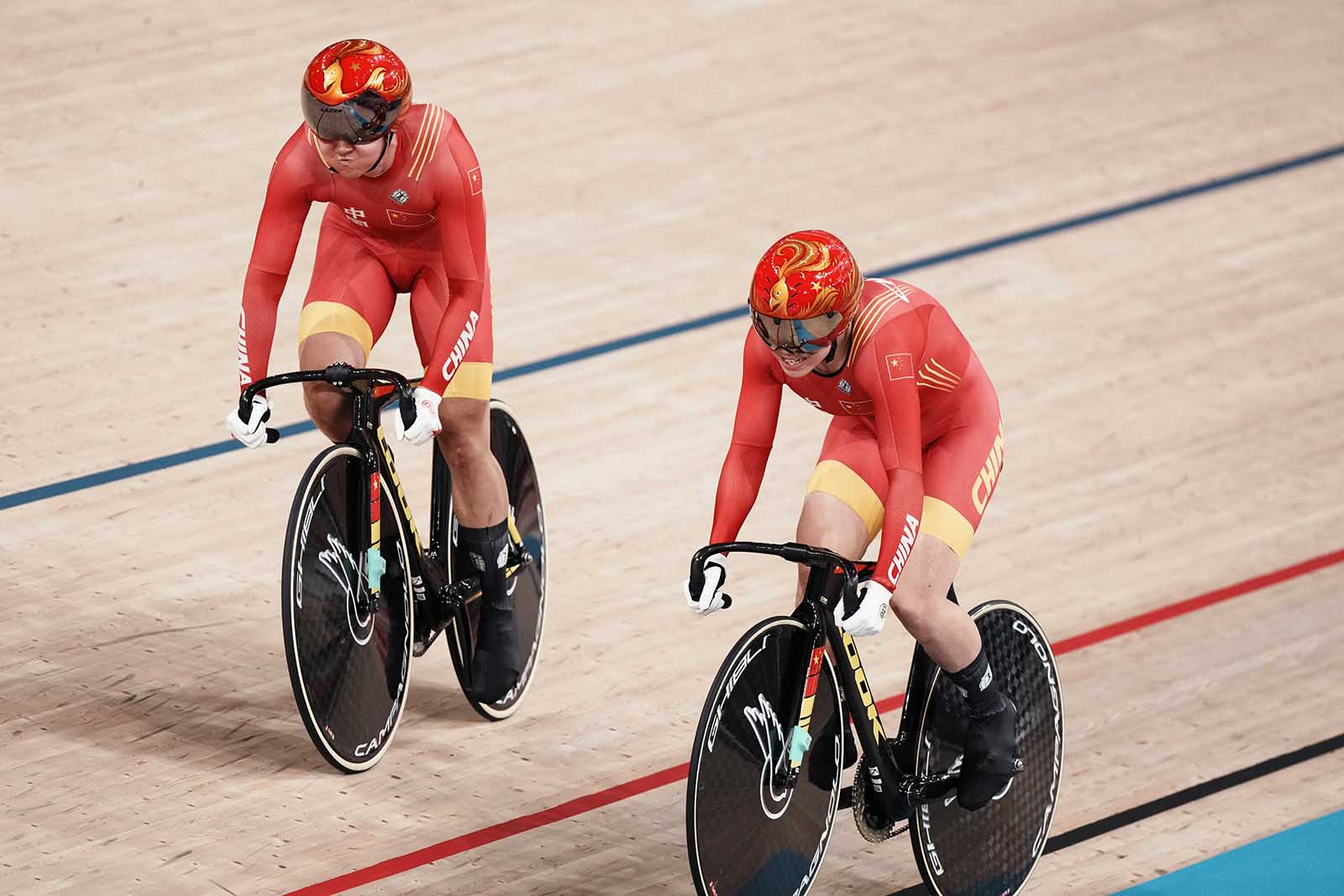 Zhong Tianshi and Bao Shanju of China compete during a qualifying heat for women's track cycling team sprint on Monday, August 2, in Izu, Japan.