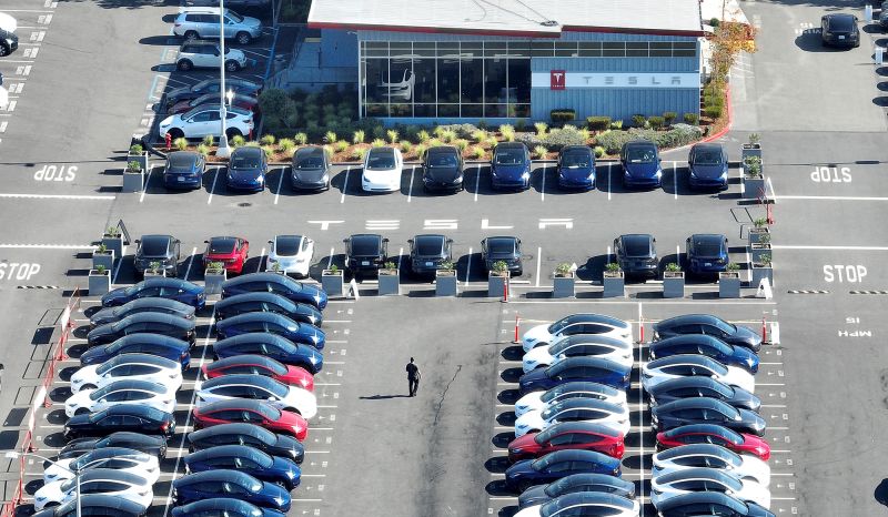Brand new Tesla cars sit in a parking lot at the Tesla factory on October 19, 2022 in Fremont, California. 