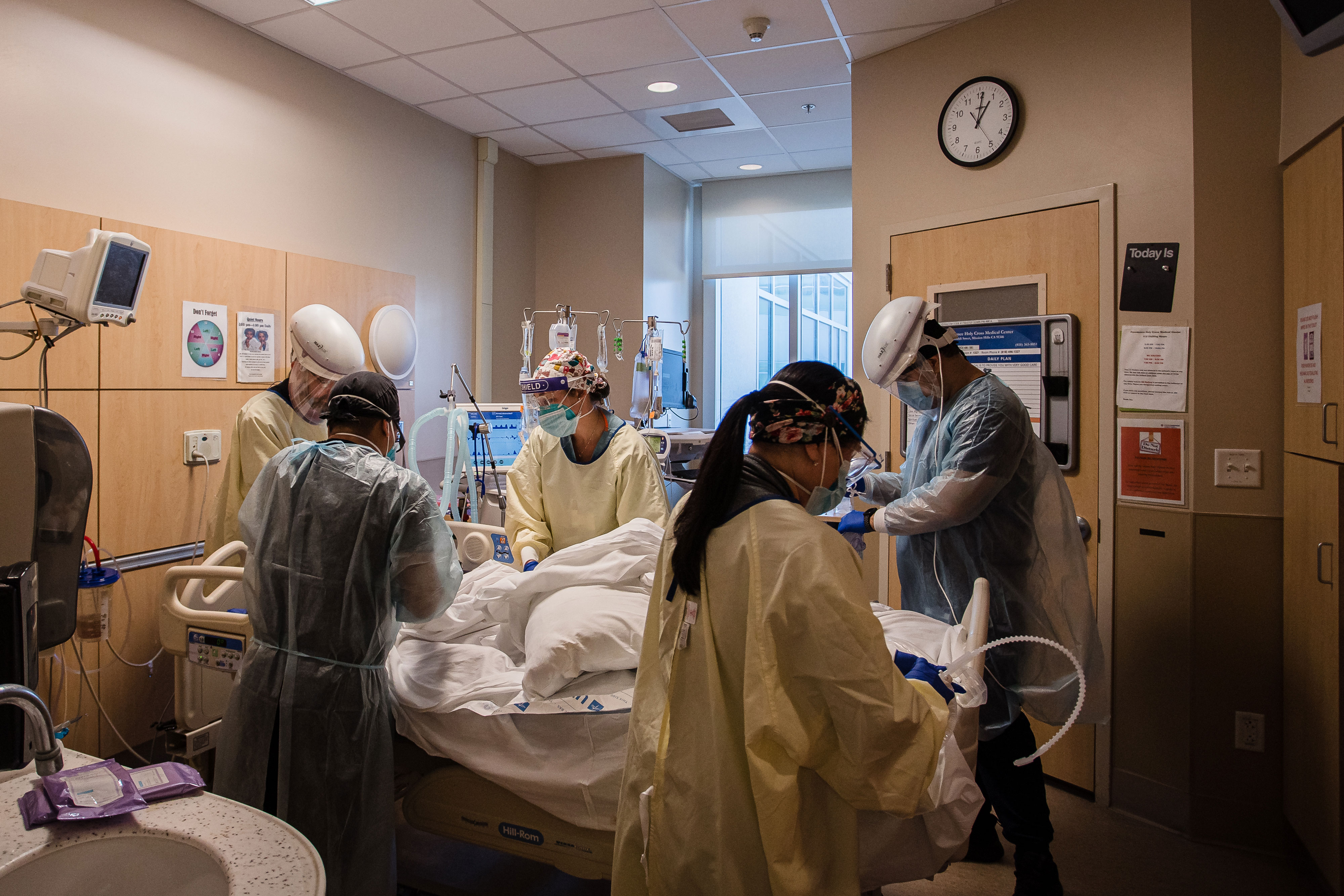 Health care workers assist a patient in the overflow area of the Covid-19 intensive care unit at Providence Holy Cross Medical Center - Mission Hills in Los Angeles on February 5.