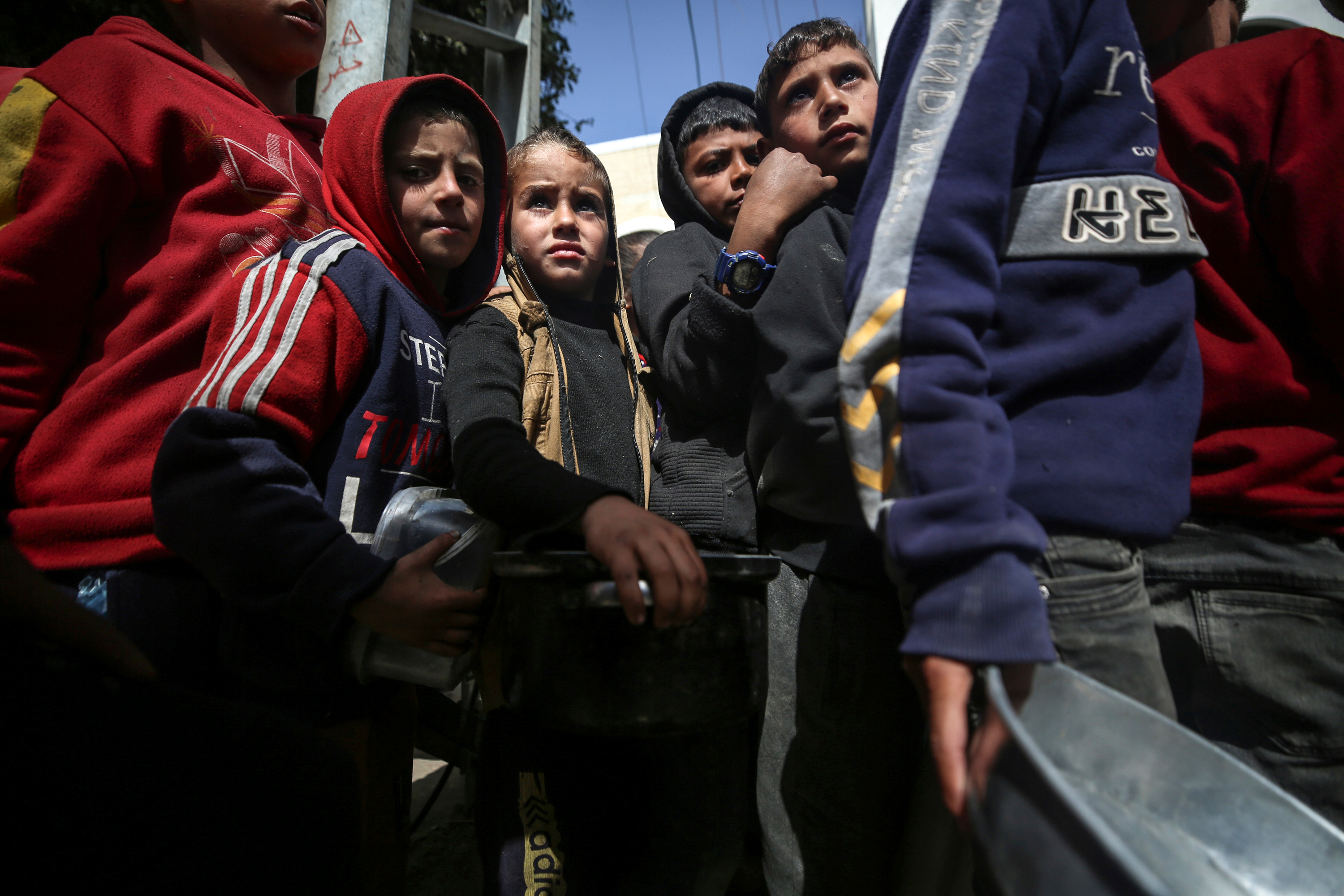 Children gather to receive food at a donation point in Deir al-Balah, Gaza on March 6.