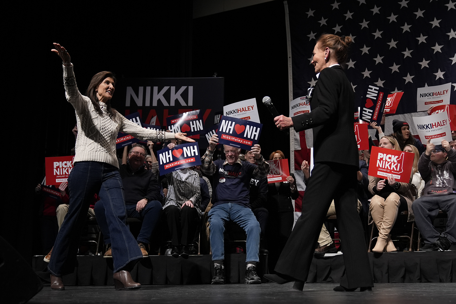 Republican presidential candidate former UN Ambassador Nikki Haley, left, walks to embrace Judge Judy Sheindlin, right, during a campaign event Exeter High School in Exeter, N.H., Sunday, Jan. 21.