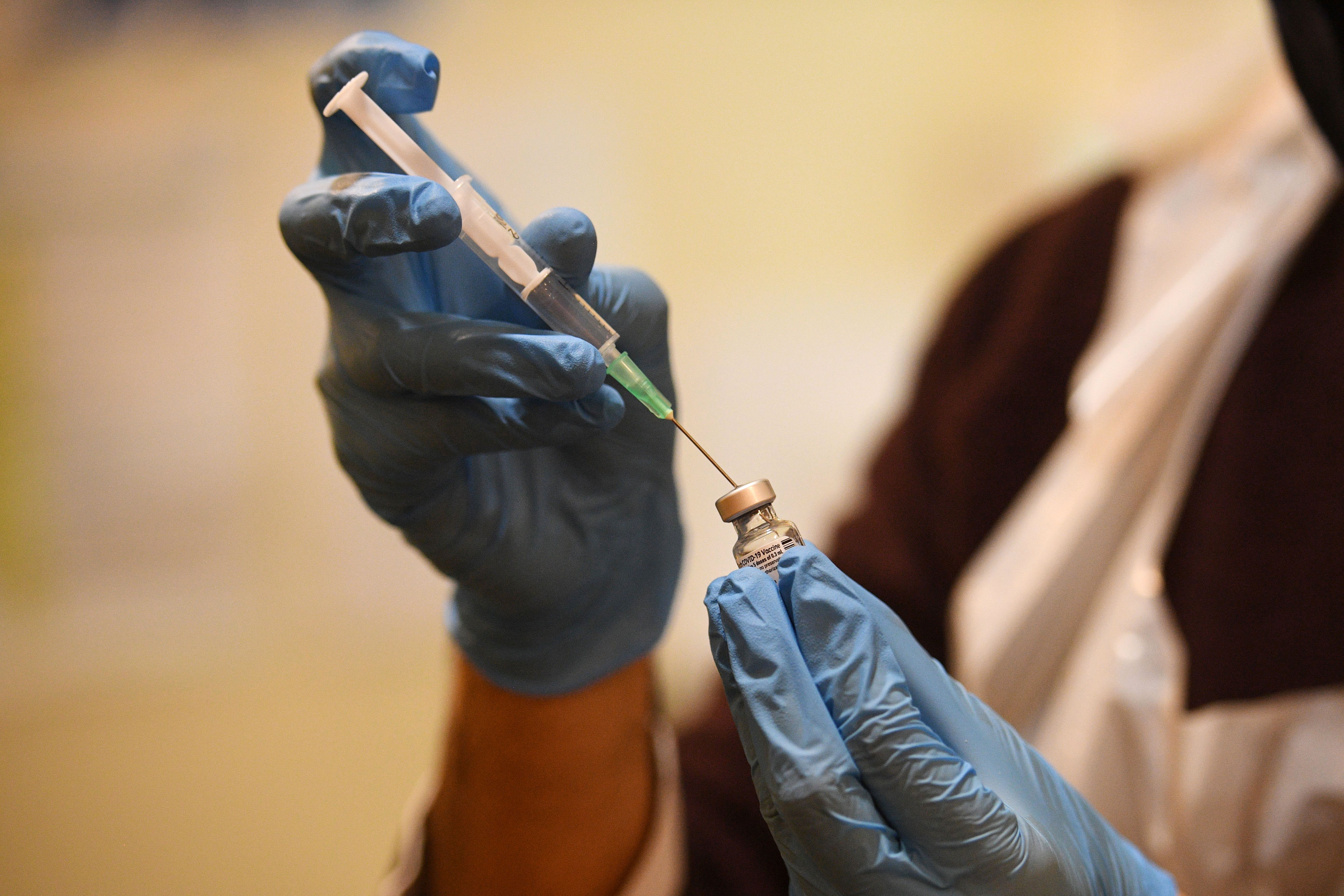 A pharmacist prepares a vial of the Pfizer/BioNTech Covid-19 vaccine before doses are administered in Thornton-Cleveleys, England, on January 29.