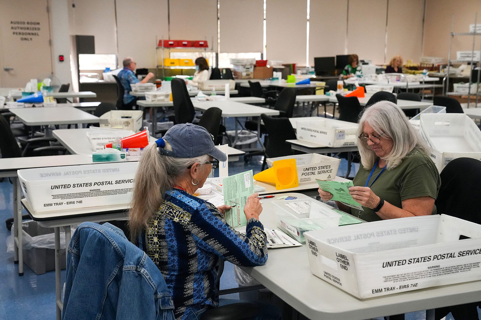 Election workers process ballots at Maricopa County Tabulation and Election Center on November 13, in Phoenix.