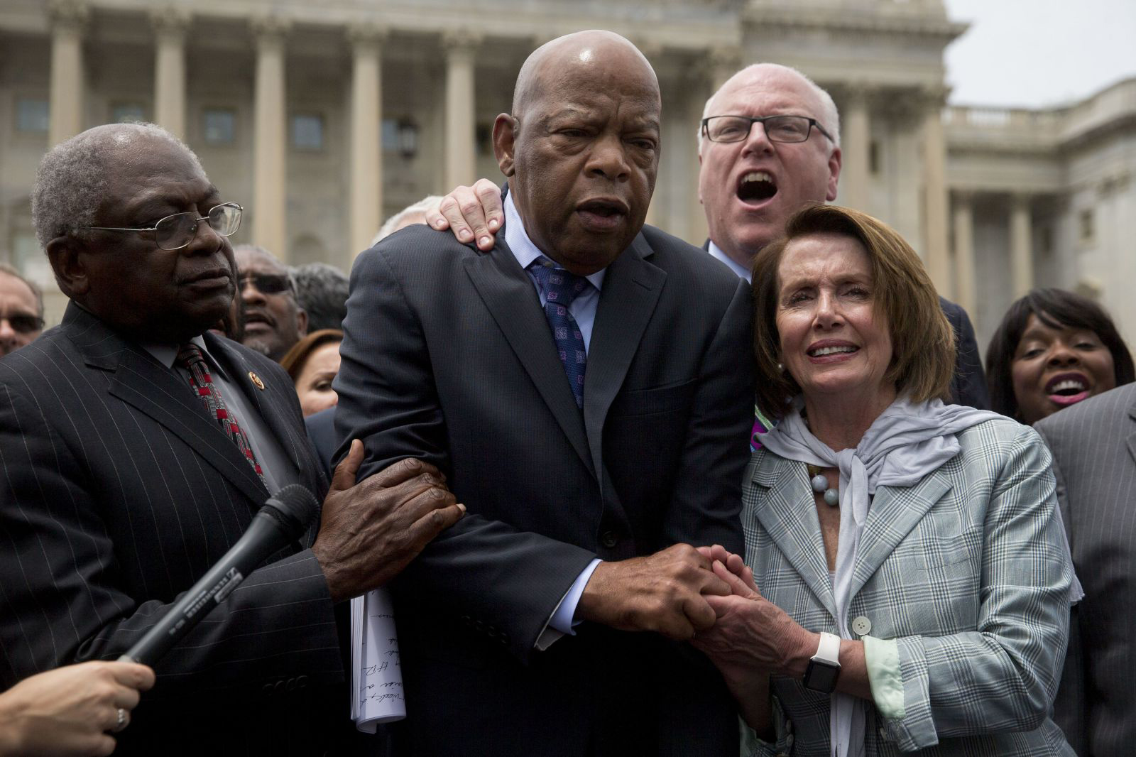 John Lewis is joined by Pelosi and US Reps. Jim Clyburn and Joe Crowley as Democrats sing a song outside the US Capitol in June 2016. Democrats were closing out a marathon sit-in on the House floor after 25 hours of emotionally charged speeches demanding action on gun control.