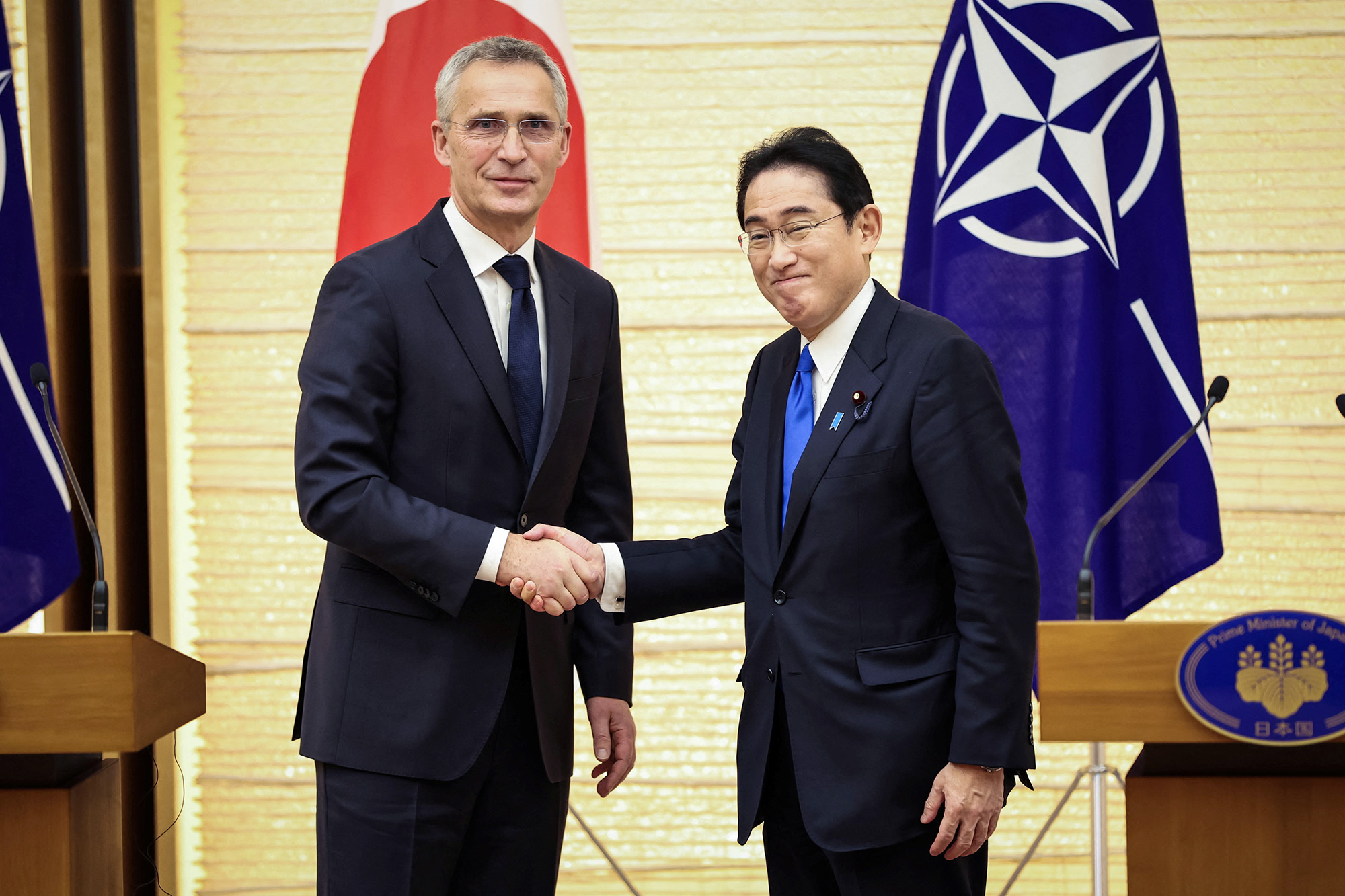 NATO Secretary General Jens Stoltenberg, left, and Japan's Prime Minister Fumio Kishida shake hands after holding a joint media briefing on January 31, in Tokyo, Japan. 