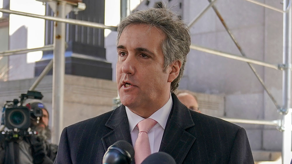 Michael Cohen, center speaks to reporters on March 15, in New York. 