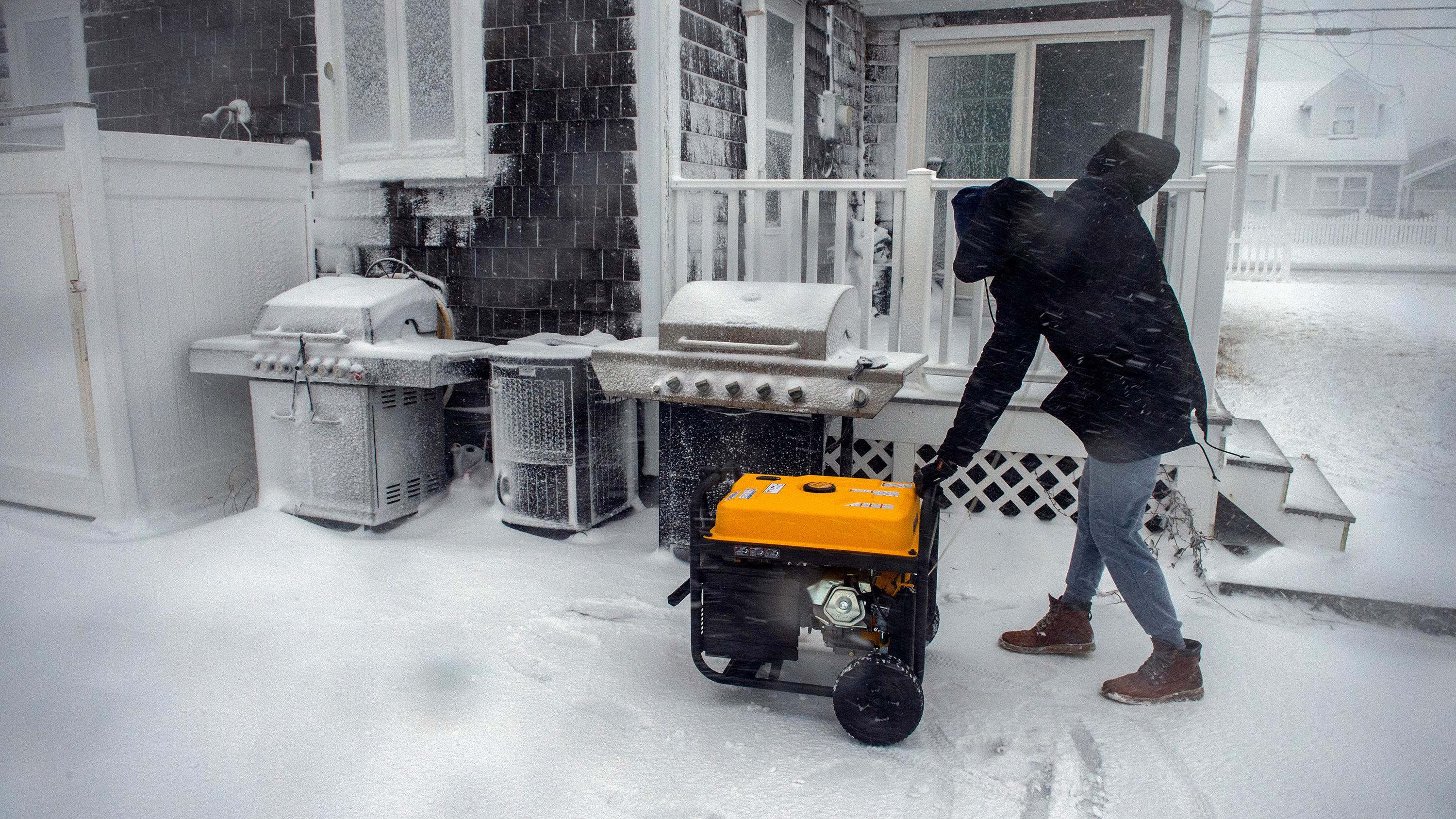 A man starts a generator after losing power at his home in Marshfield, Massachusetts, on January 29. 