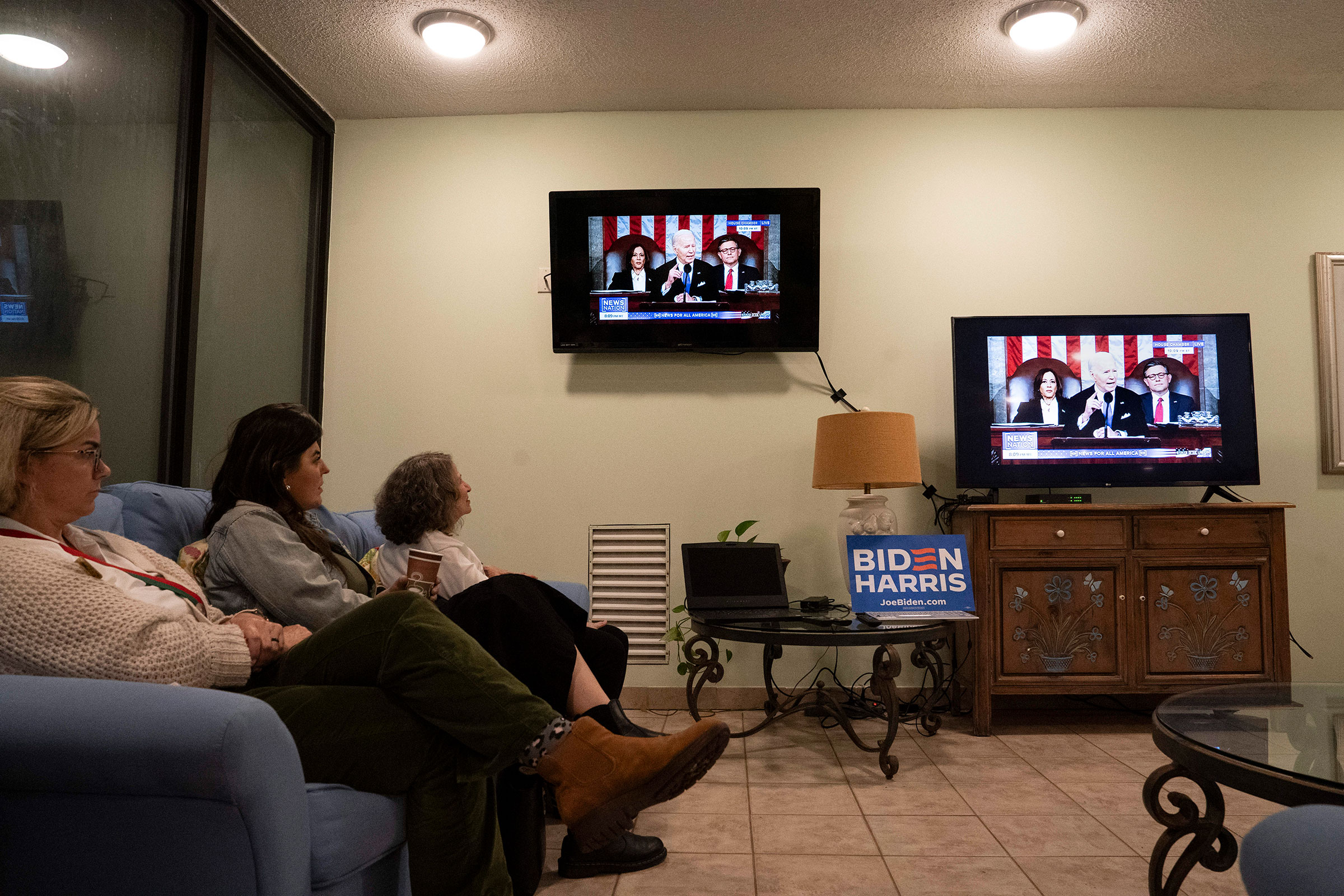 People watch President Biden speak at a State of the Union watch party organized by the New Hanover Democratic Party on March 7 in Wrightsville Beach, North Carolina. 