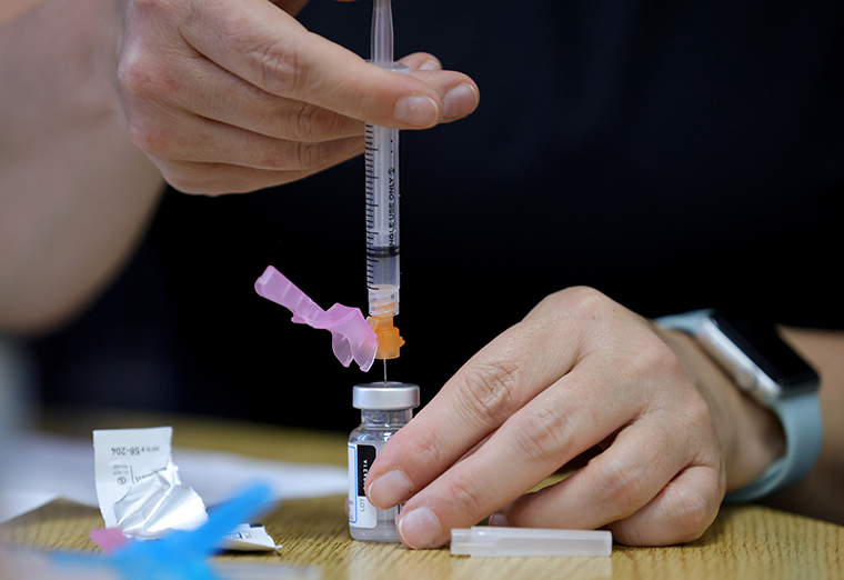 A registered nurse measures a vaccine dose at a community COVID-19 vaccination clinic on March 23, 2021 in Severn, Maryland. 