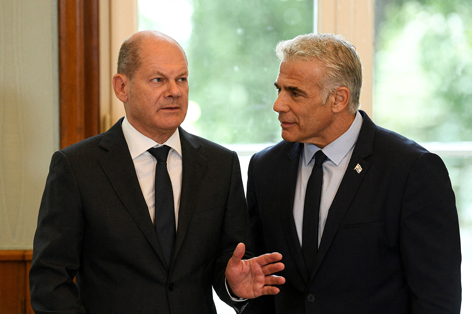 German Chancellor Olaf Scholz, left, and Israeli Prime Minister Yair Lapid speak at the House of the Wannsee Conference in Berlin,  on Monday. 