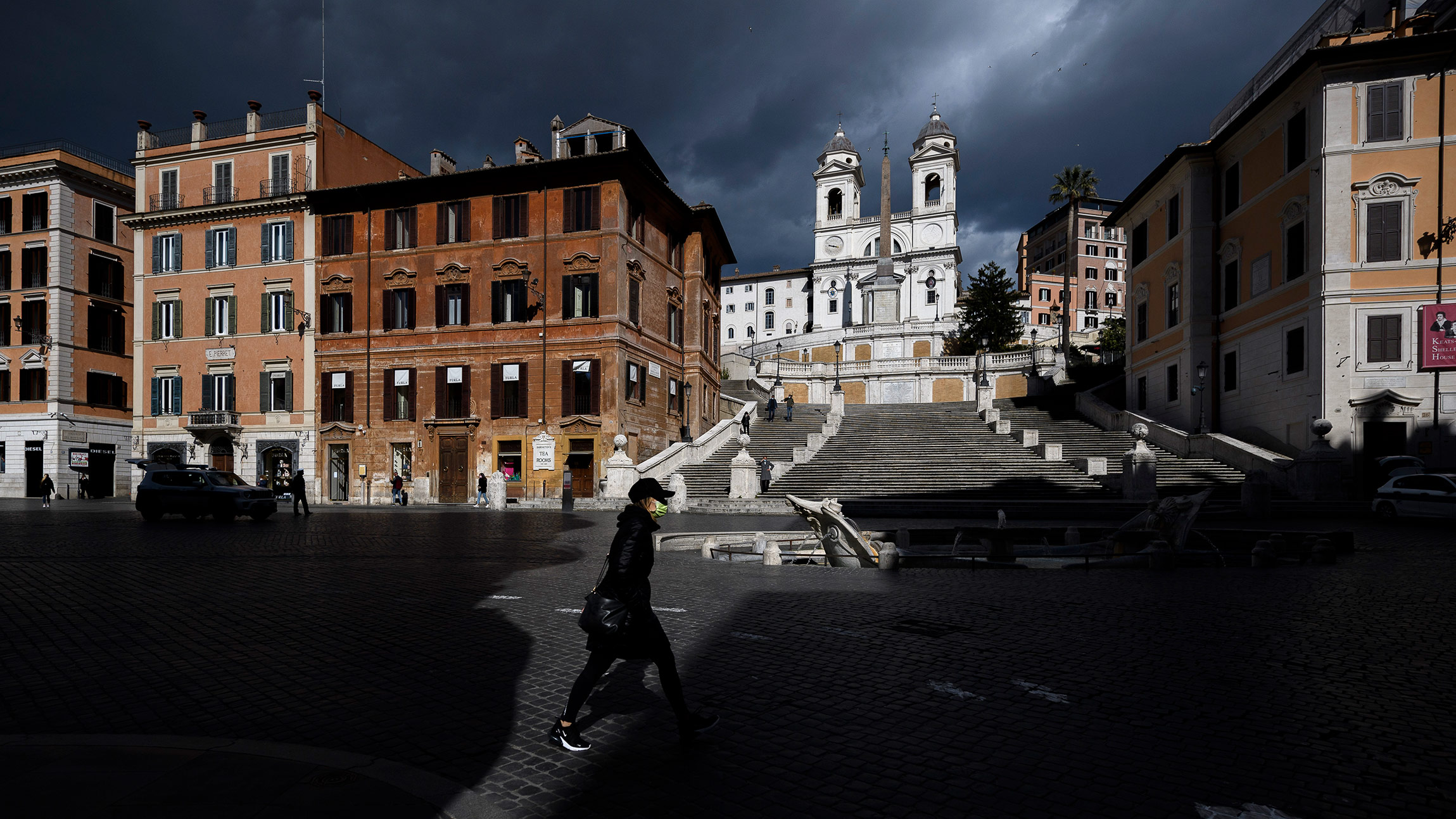 A woman walks around the empty Piazza di Spagna during the first day of lockdown in Rome, Italy, on March 15. 