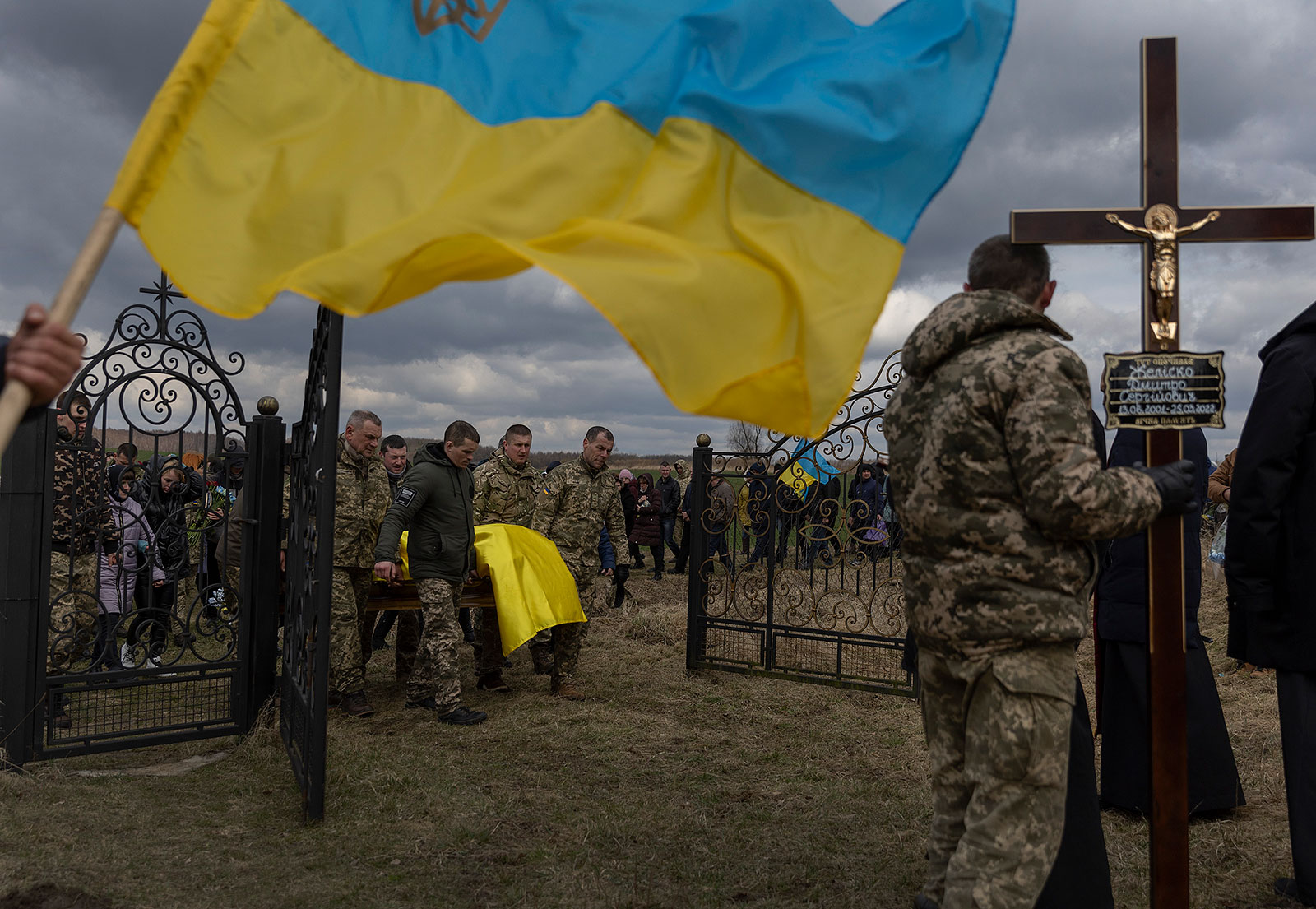 Ukrainian military members carry the casket of fellow soldier Dmitry Zhelisko to his grave site on Sunday in Rusyn. 