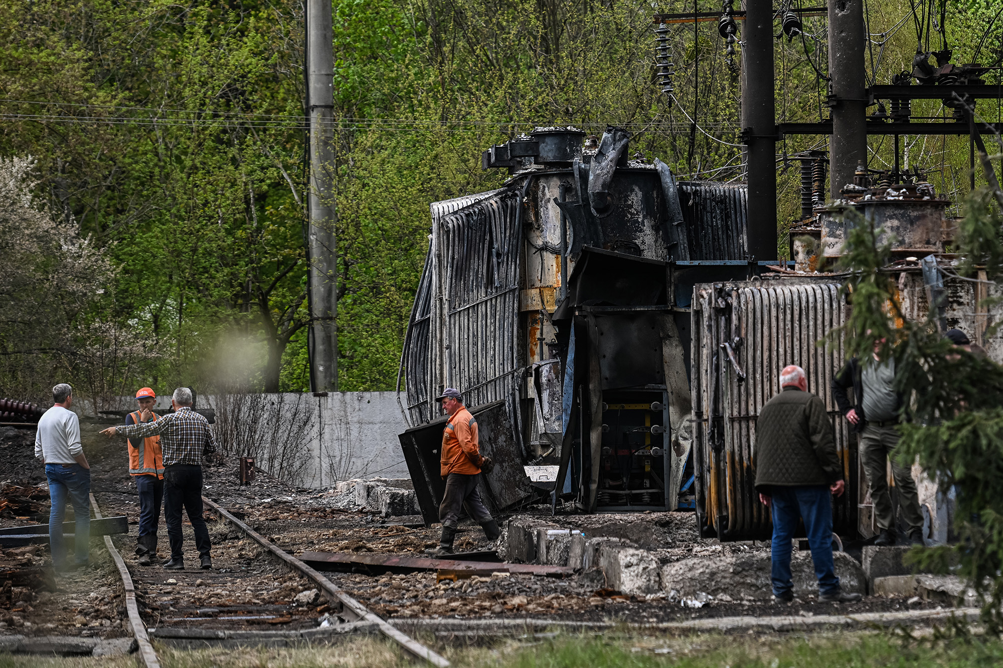 Workers inspect the electric substation that was hit by a Russian missile strike in Lviv, Ukraine on May 4.