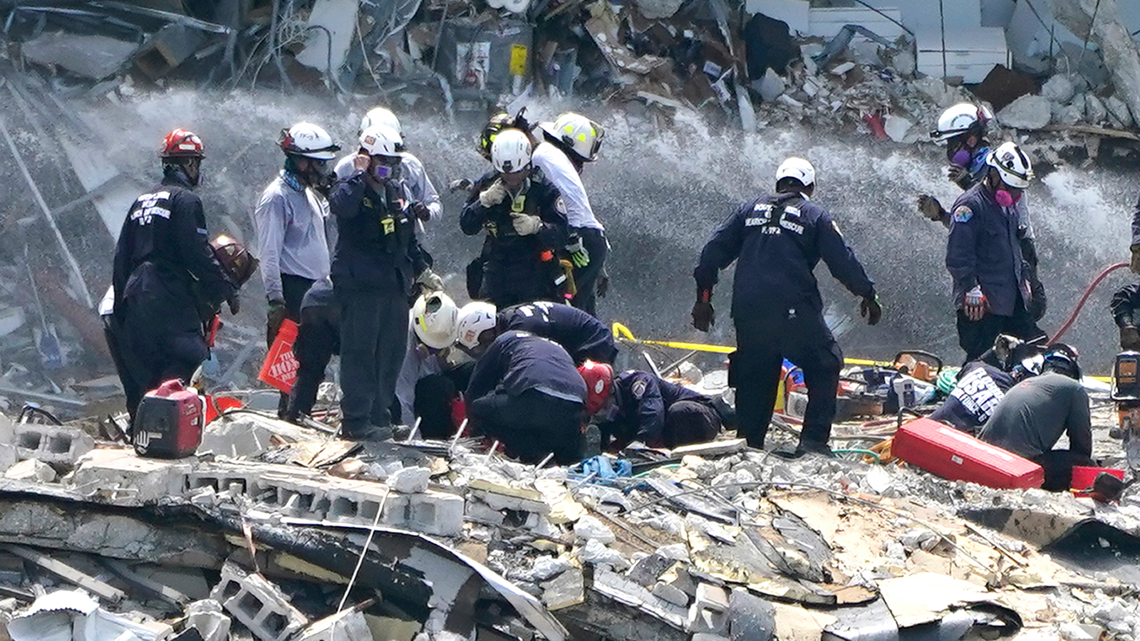 Rescue workers search the rubble of the Champlain Towers South condominium, Saturday, June 26, in the Surfside area of Miami.