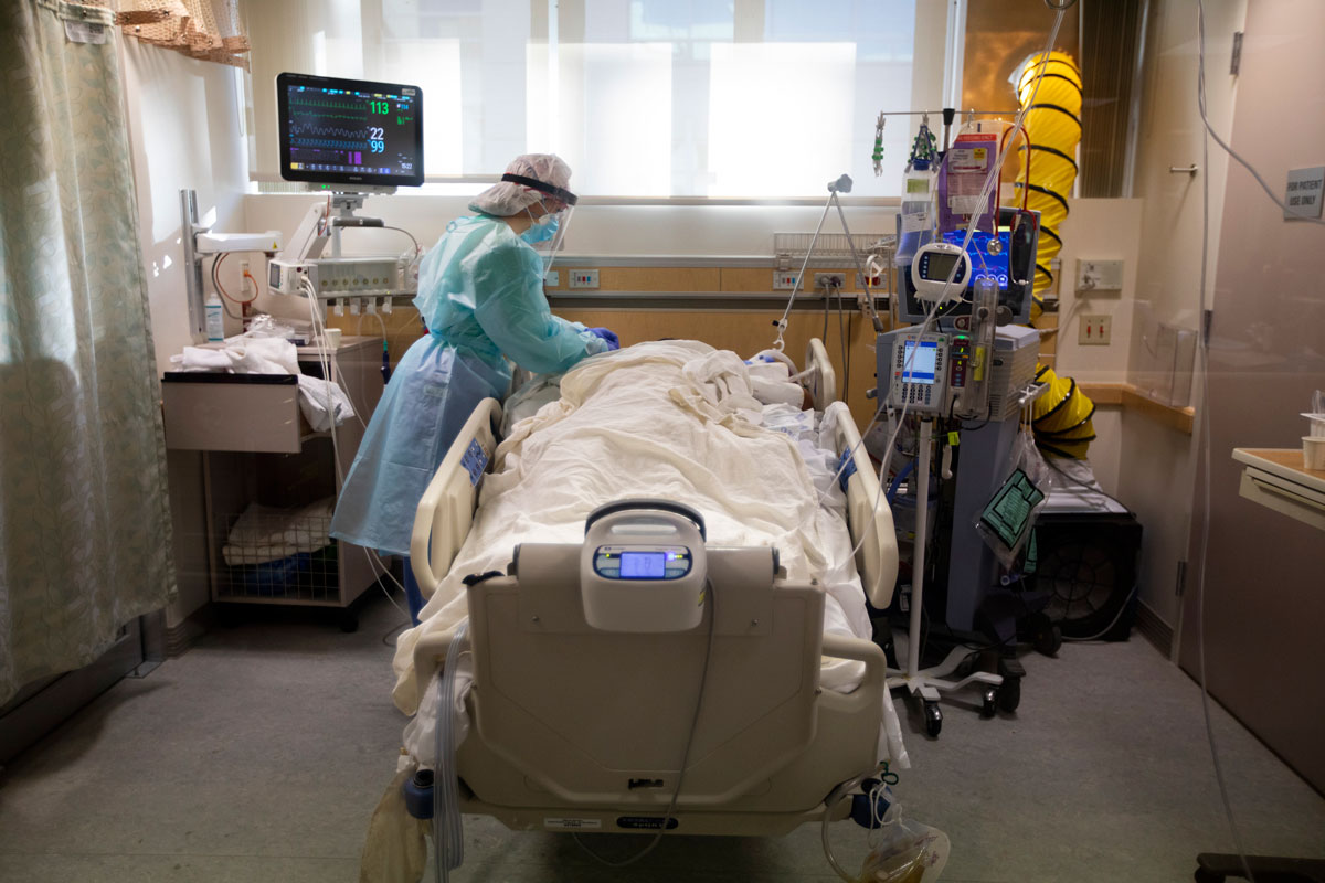 A nurse works with a Covid-positive patient inside the ICU at Providence St. Jude Medical Center on December 25 in Fullerton, California.