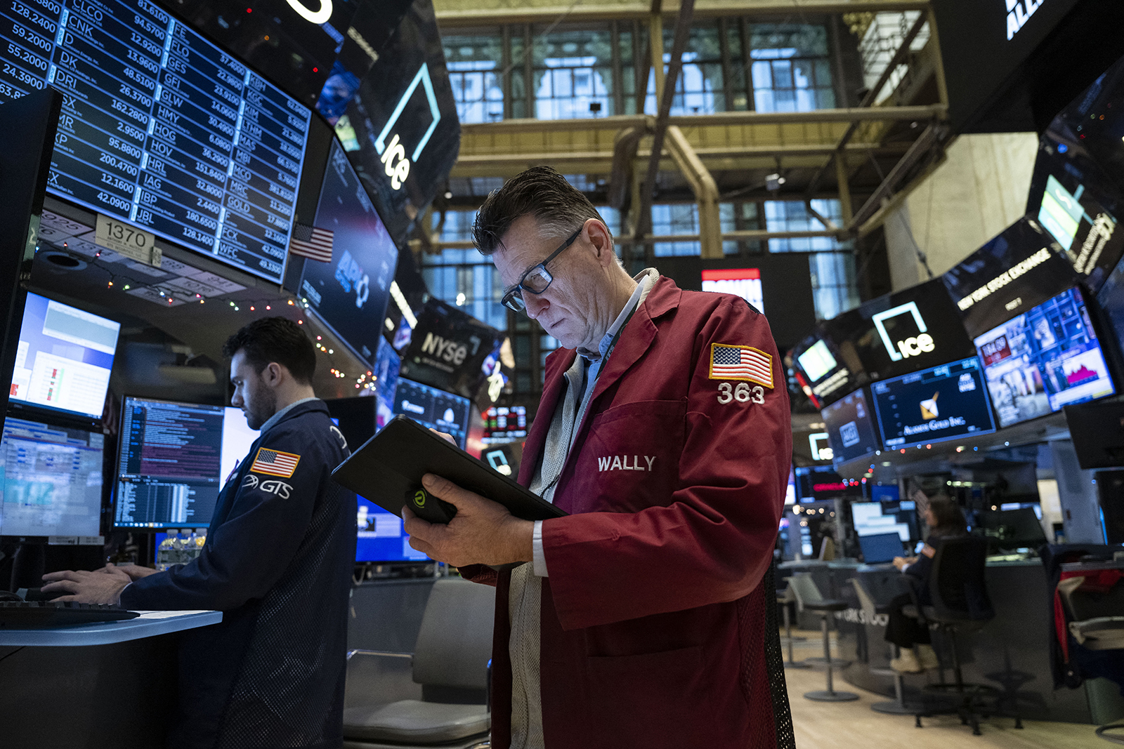 Traders work on the floor of the New York Stock Exchange (NYSE) during morning trading on January 3, 2024, in New York City. 