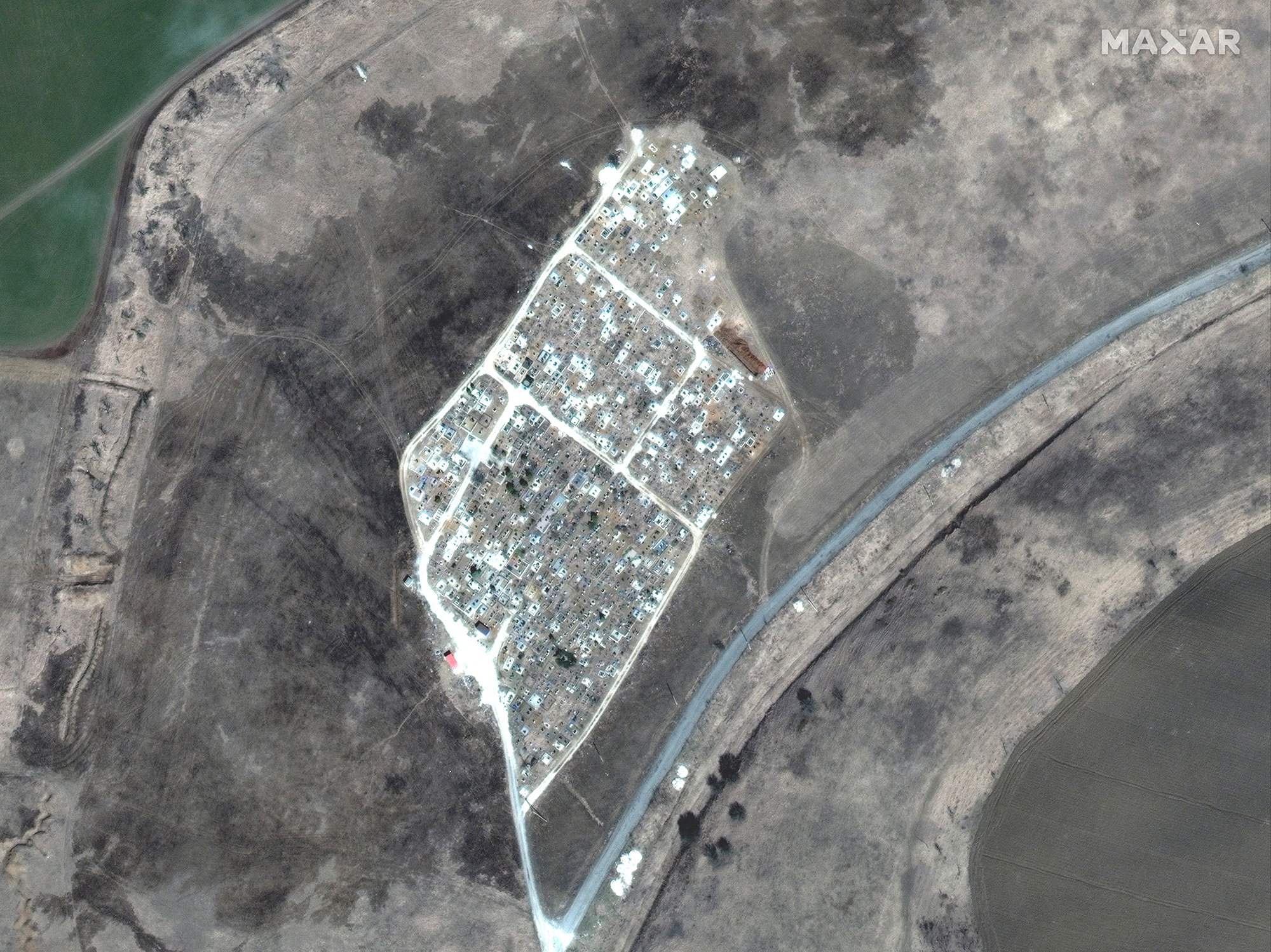 An image taken by satellite shows the expansion of new graves at a cemetery in Vinohraden, near Mariupol, Ukraine, on March 29.