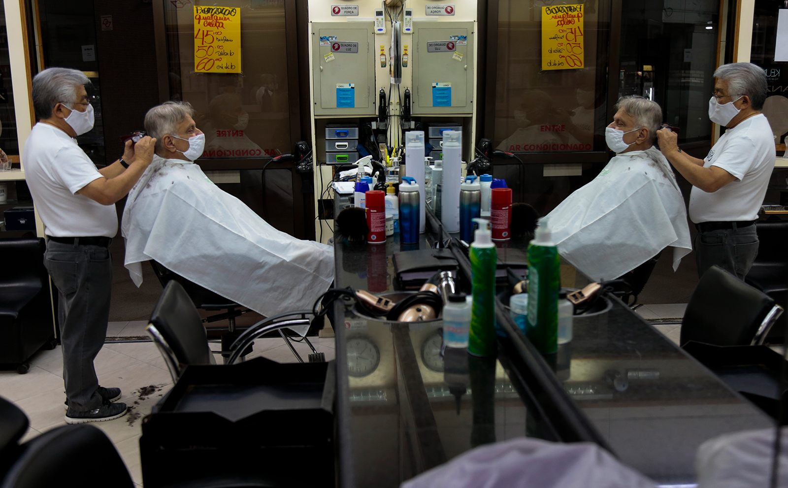 A hairdresser works on a customer after reopening amid the easing of quarantine measures on July 6, in Sao Paulo, Brazil.