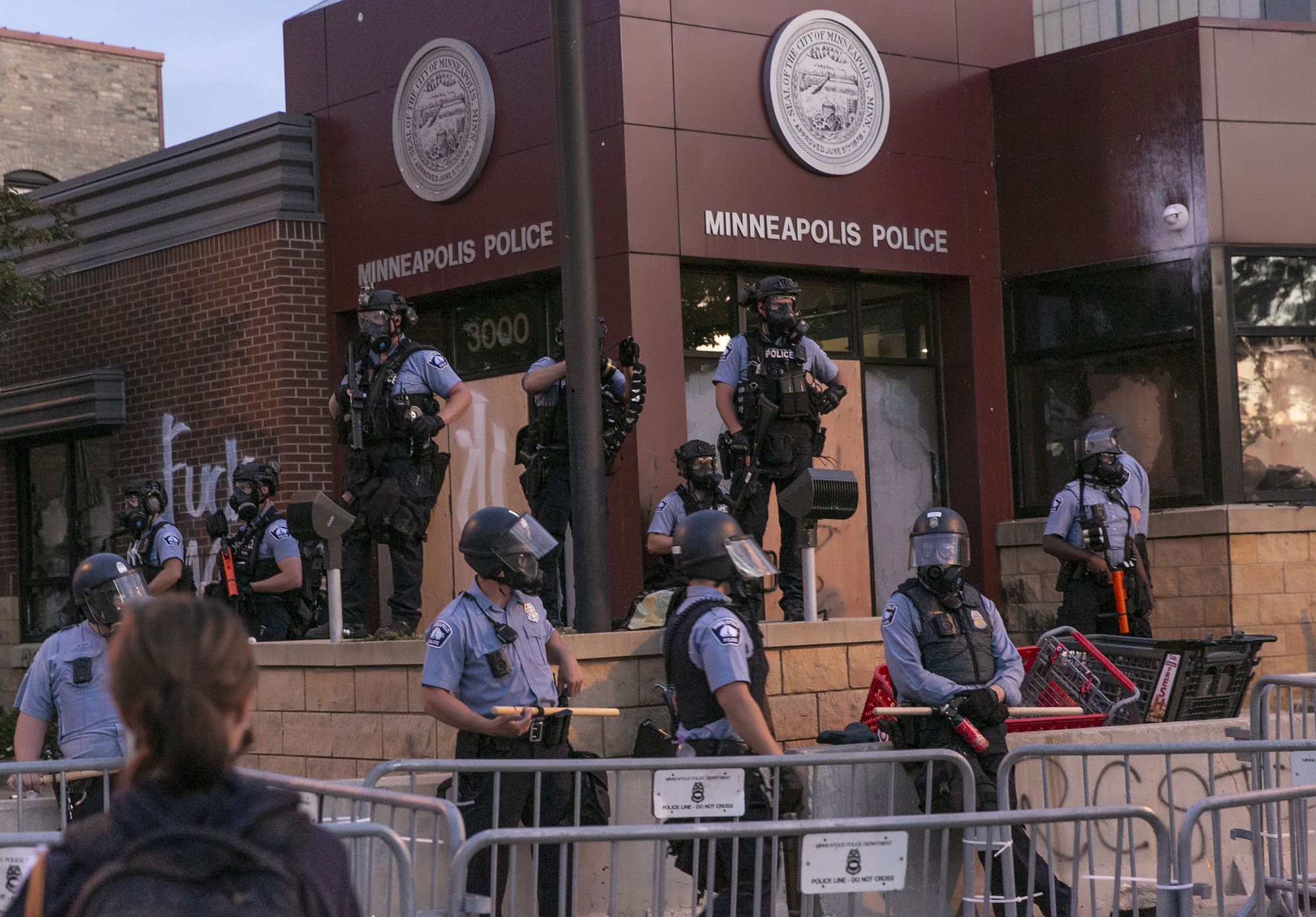 Police stand guard at the 3rd precinct on May 27 during the second day of protests over the death of George Floyd in Minneapolis. 
