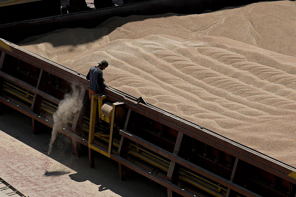 An employee of the Romanian grain handling operator Comvex oversees the unloading of a shipment from the Ukraine in the Black Sea port of Constanta, Romania, on June 21, 2022.