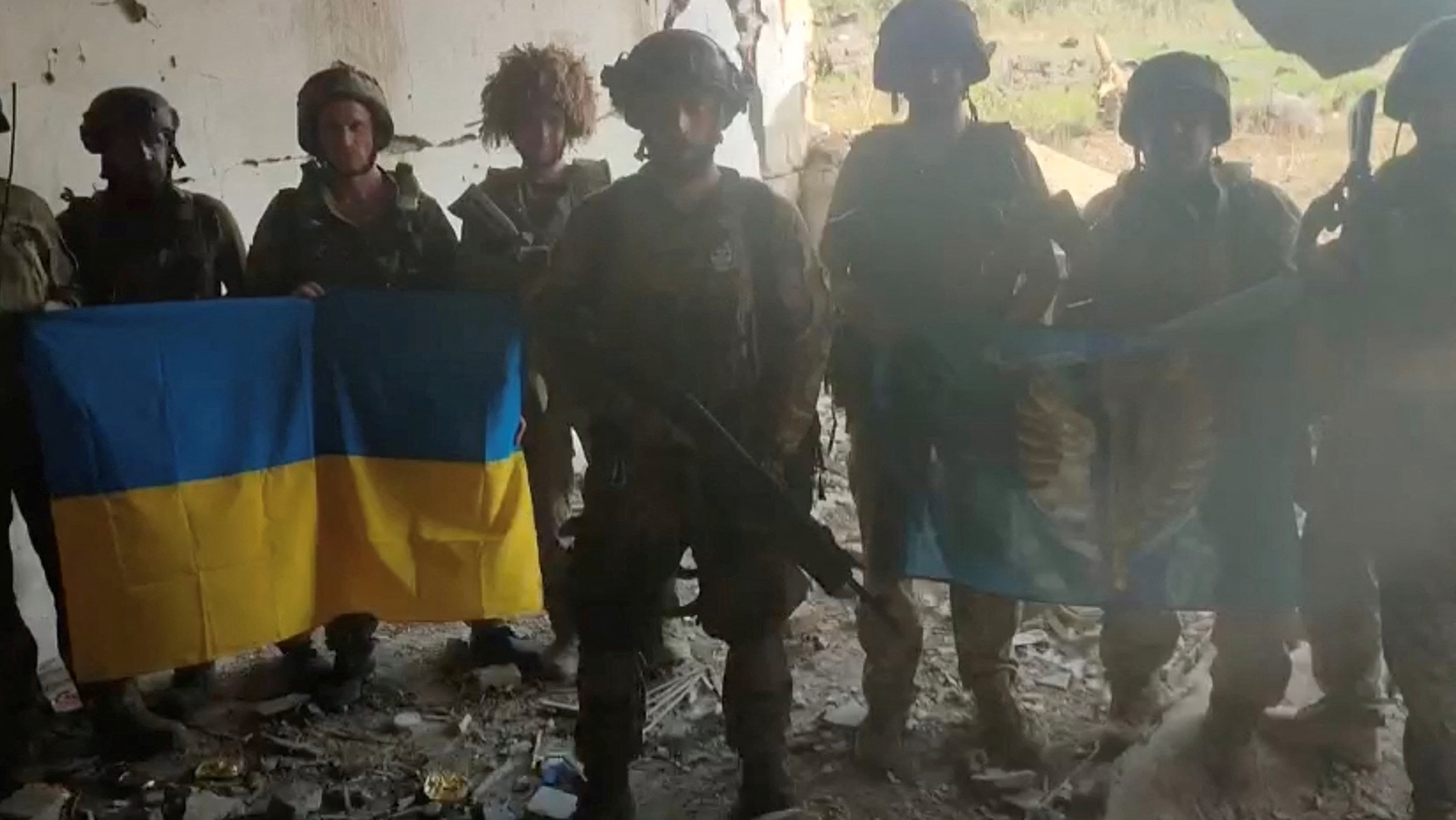Ukrainian soldiers are seen in the Ukrainian village of Staromaiorske, in this screen grab from video posted by Ukrainian President Volodymyr Zelensky on July 27.
