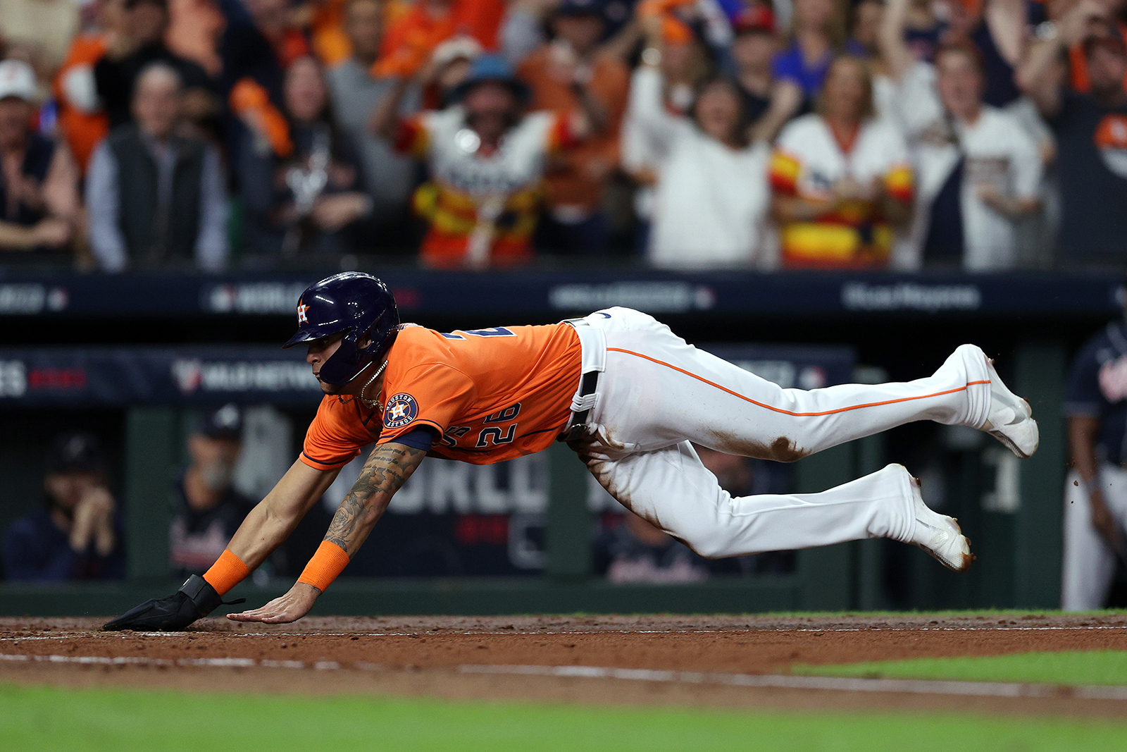 Jose Siri of the Houston Astros slides in safely at home plate to score a run against the Atlanta Braves during the second inning.
