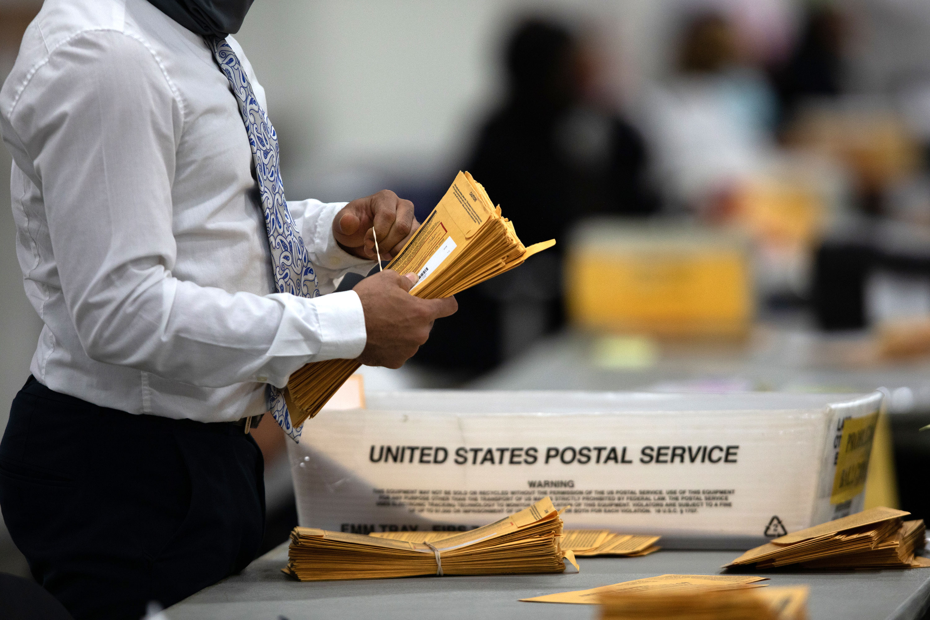 A volunteer processes absentee ballots in Detroit, Michigan, on November 4.