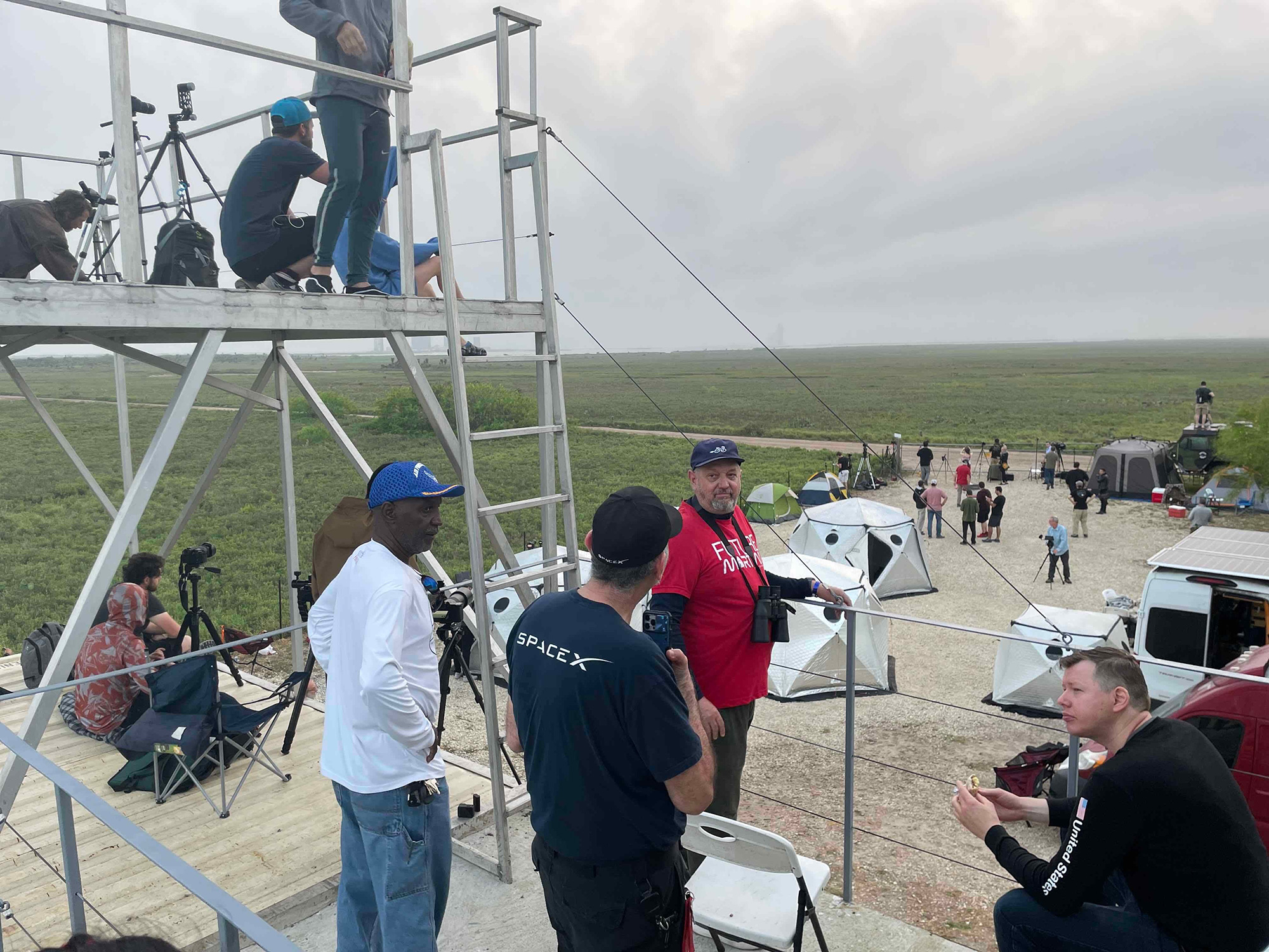 Spectators are seen at "The Outpost," a Starship viewing location set up by the local Rocket Ranch, near Boca Chica beach in Texas.