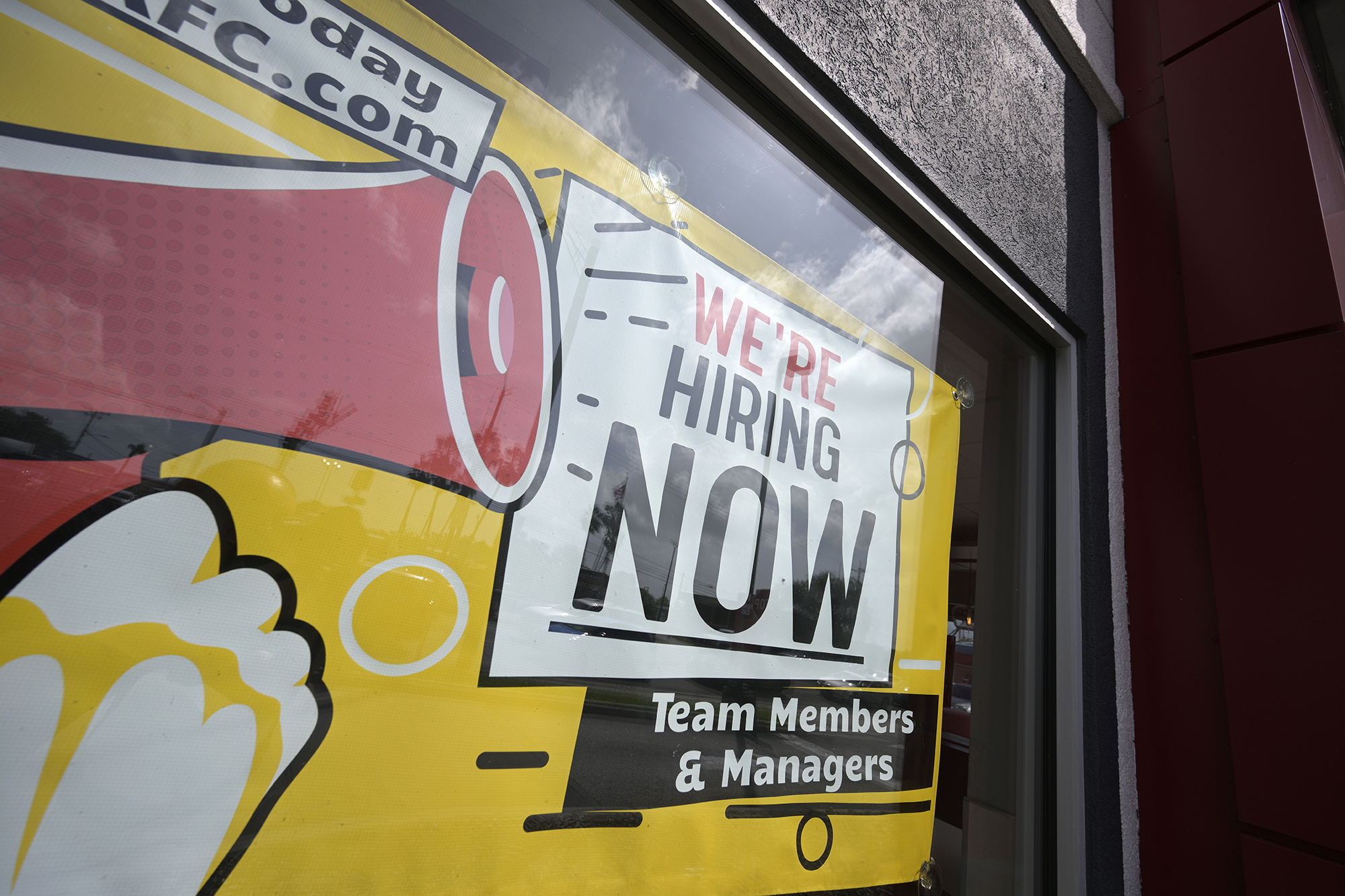 A We're Hiring Now sign advertising job openings is viewed outside a KFC restaurant, Monday, Oct. 2, 2023, in Tampa, Fla. 