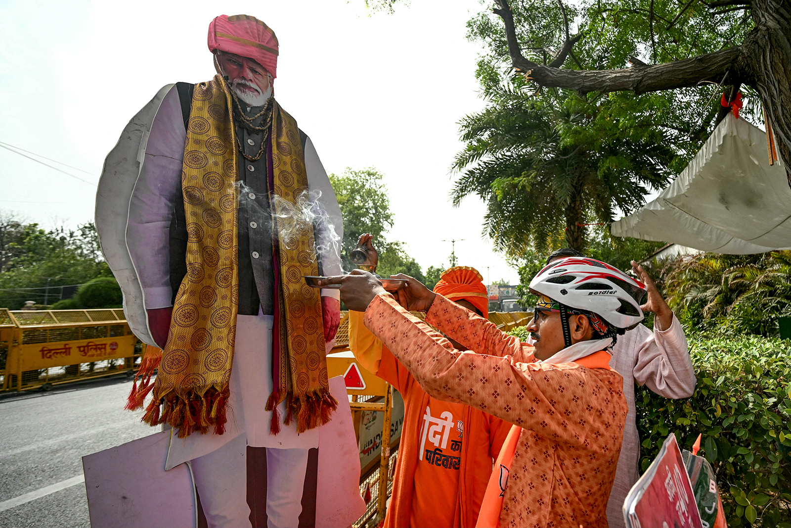 A supporter of Narendra Modi, performs rituals outside the BJP headquarters in New Delhi on June 4.