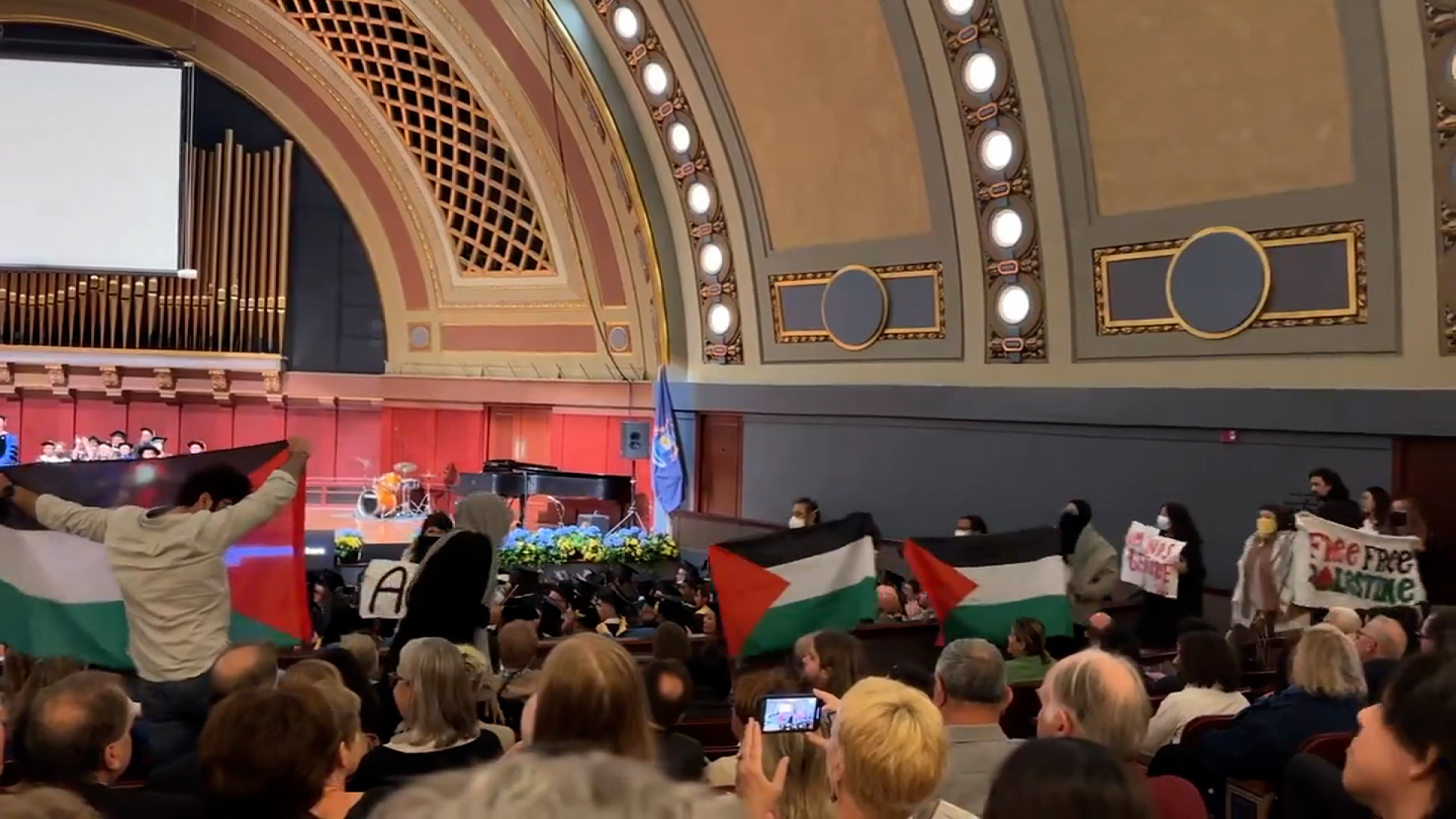 In a still from a video by the Richmond Times-Dispatch, pro-Palestinian protesters disrupt the University of Michigan School of Music, Theatre and Dance commencement ceremony.