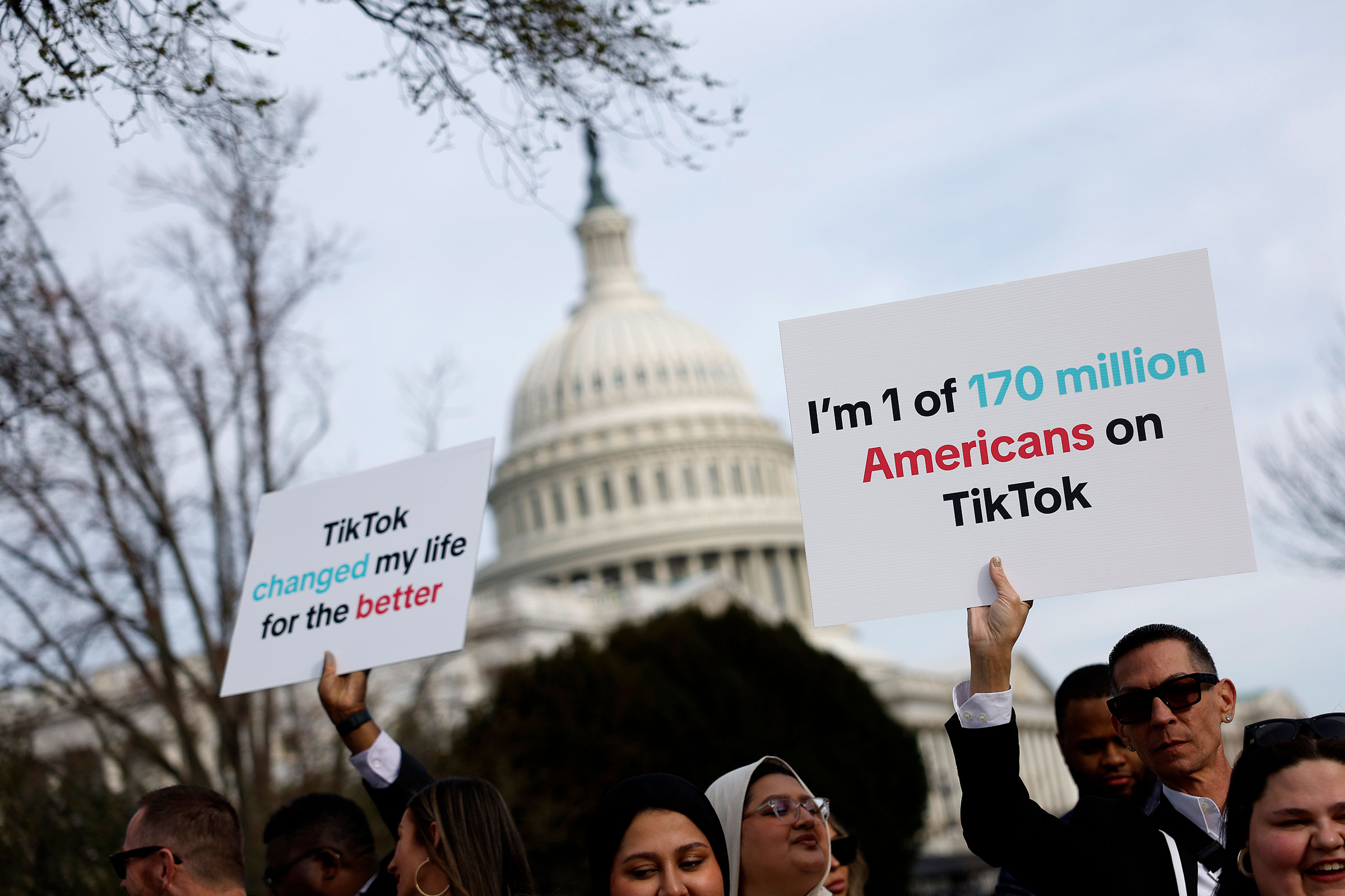  Participants hold signs in support of TikTok outside the US Capitol Building on March 13 in Washington, DC.