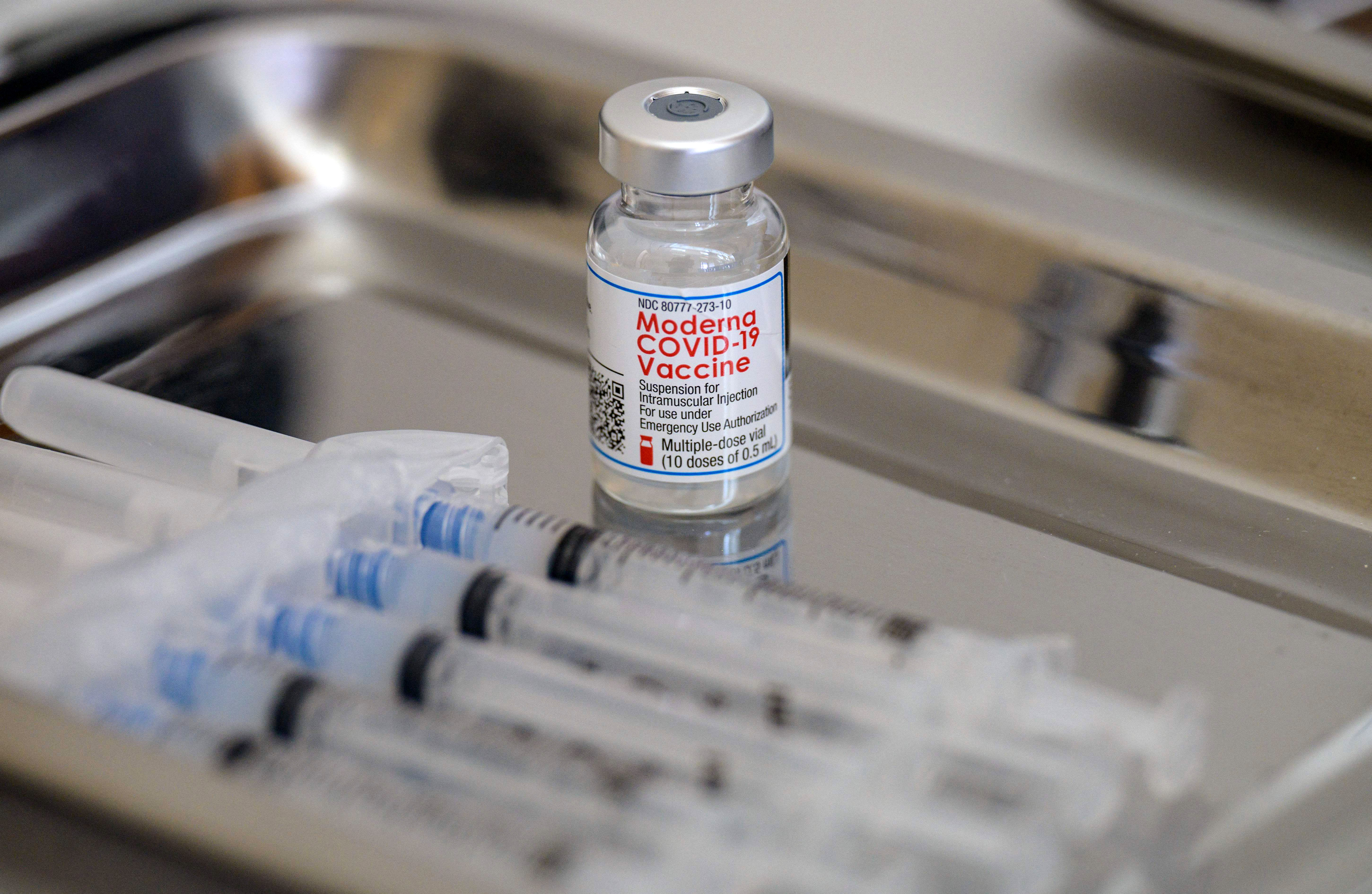 A vial of the Moderna Covid-19 vaccine and syringes are prepared in Staten Island, New York, on April 16.