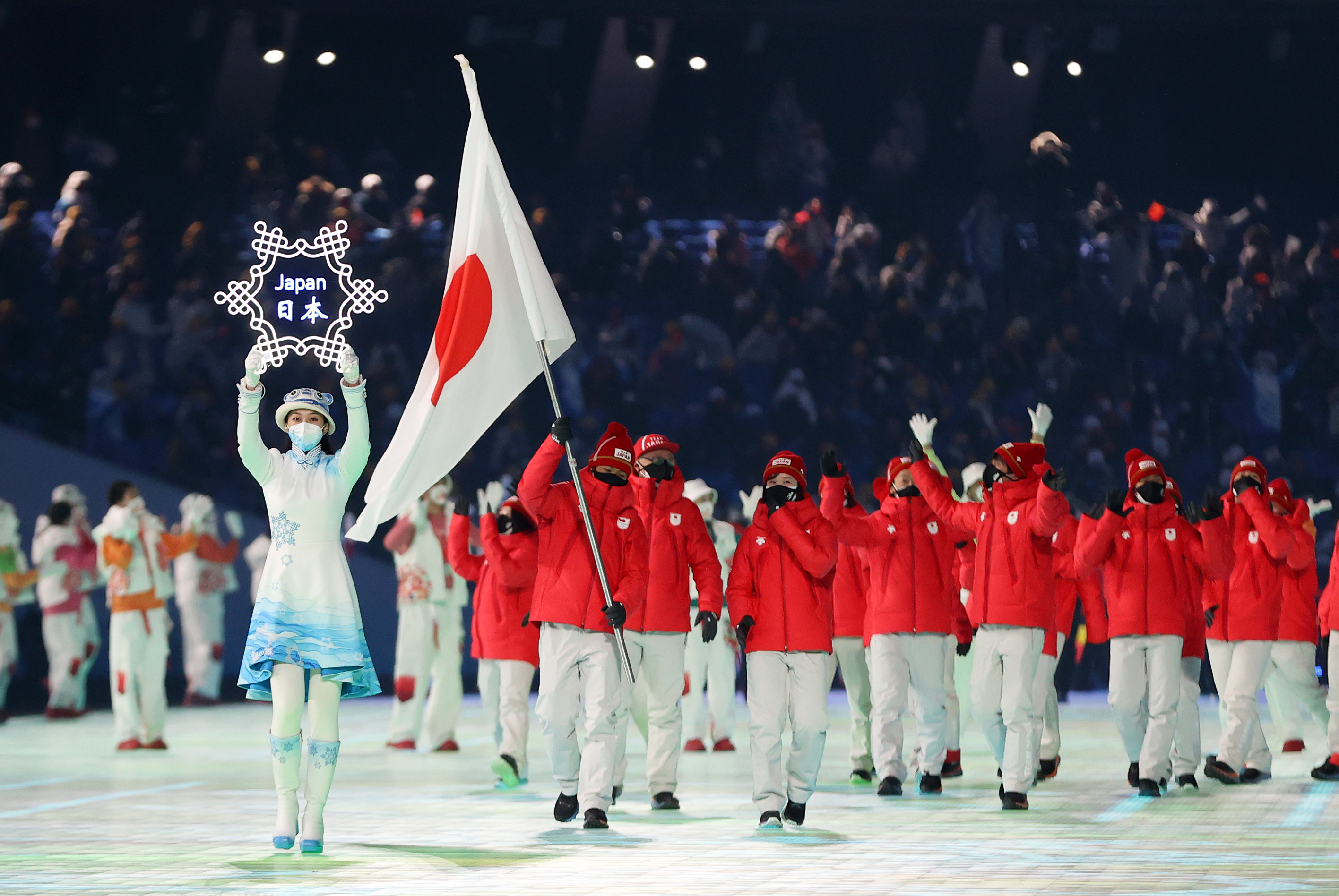 Flag bearers Arisa Go and Akito Watabe of Team Japan carry their flag during the Opening Ceremony of the Beijing 2022 Winter Olympics at the Beijing National Stadium on February 4 in Beijing, China.