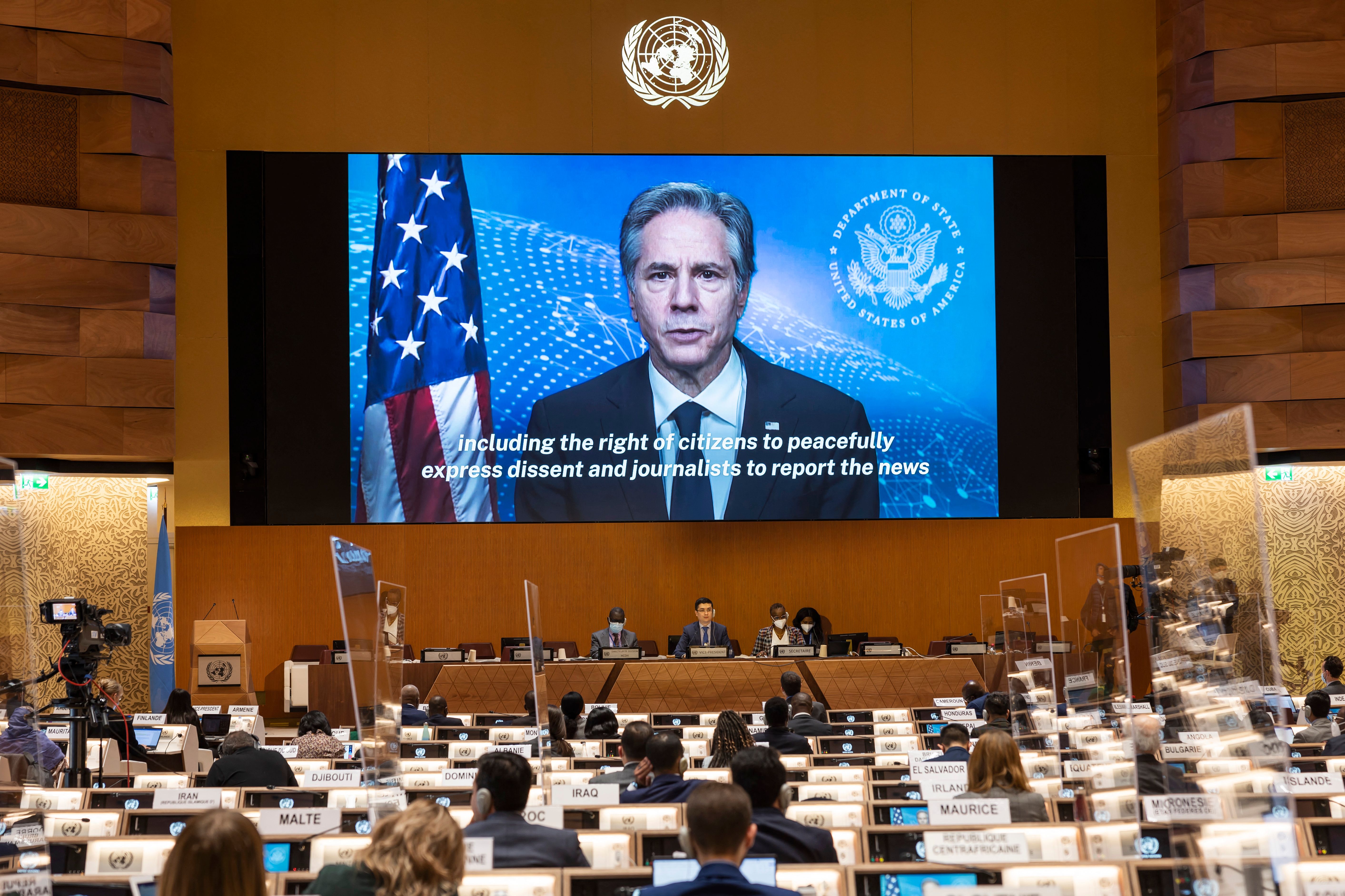 US Secretary of State Antony Blinken appears on a screen as he delivers a remote speech, during the 49th session of the UN Human Rights Council at the European headquarters of the United Nations in Geneva, Switzerland, on March 1.