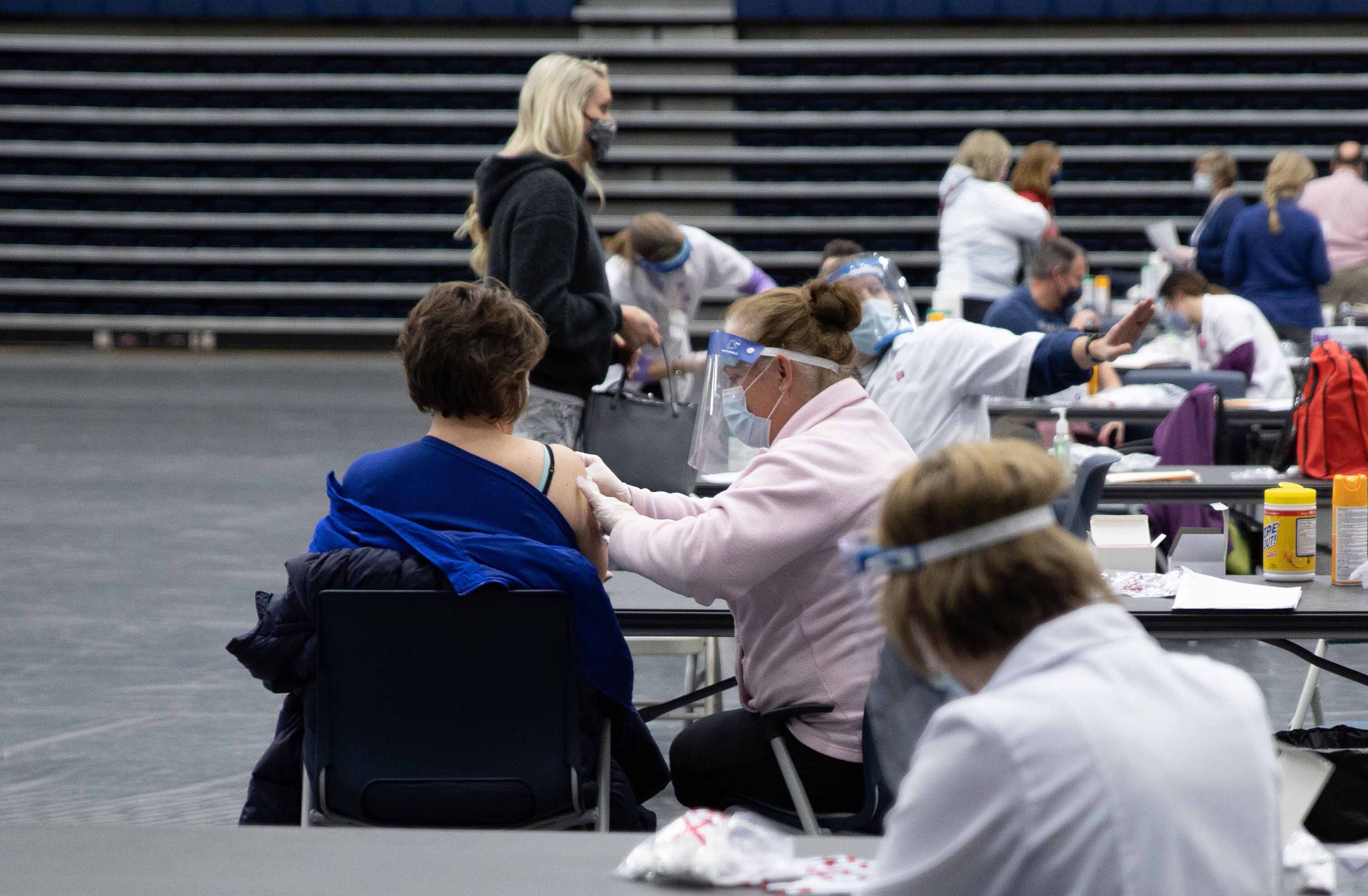 Educational staff at Kettering City Schools receive the Covid-19 vaccine as a part of Ohio's Phase 1B vaccine distribution in Dayton, Ohio, on February 10. 