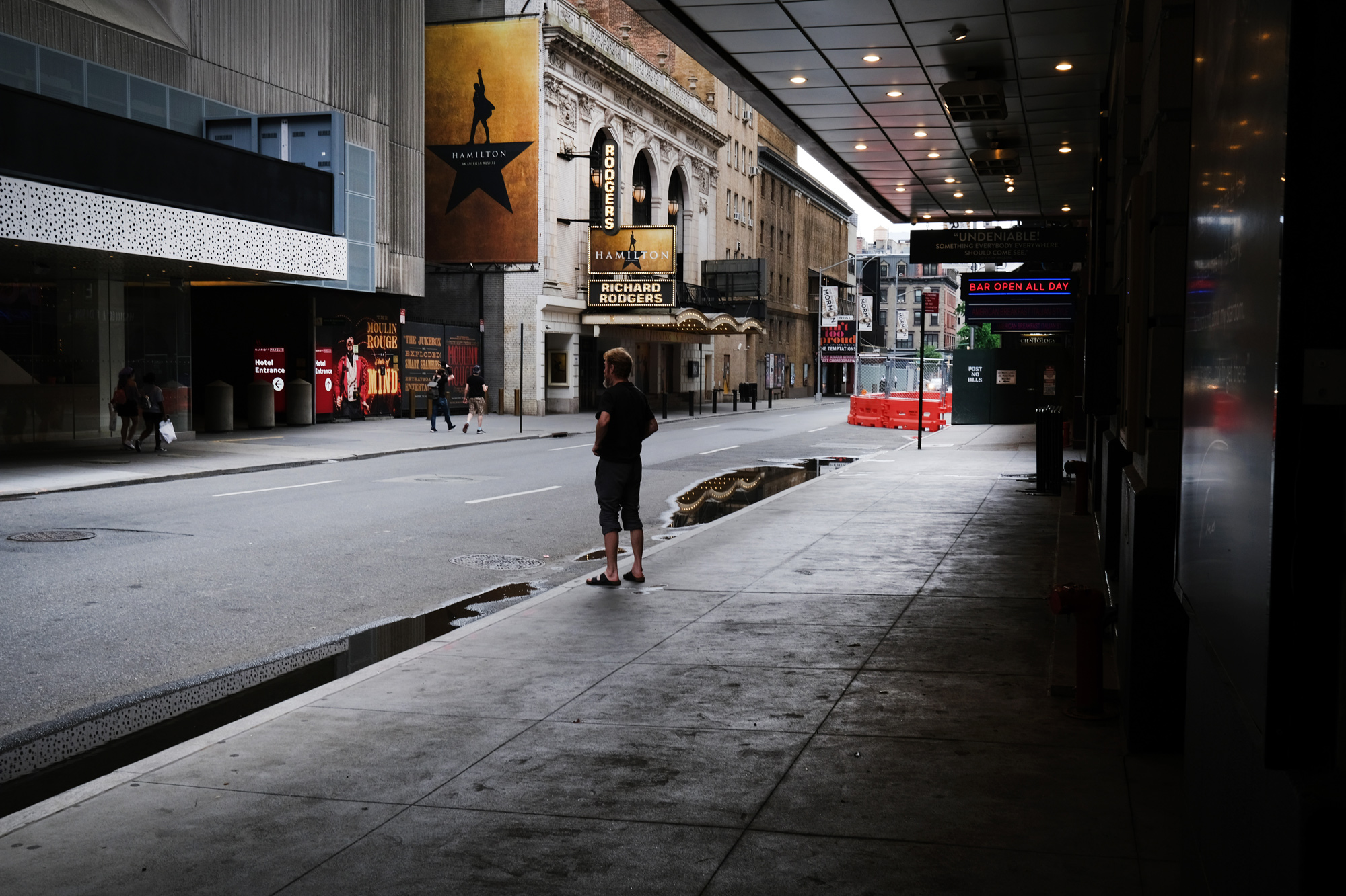 Broadway theaters stand closed along an empty street in the theater district on June 30 in New York City. 